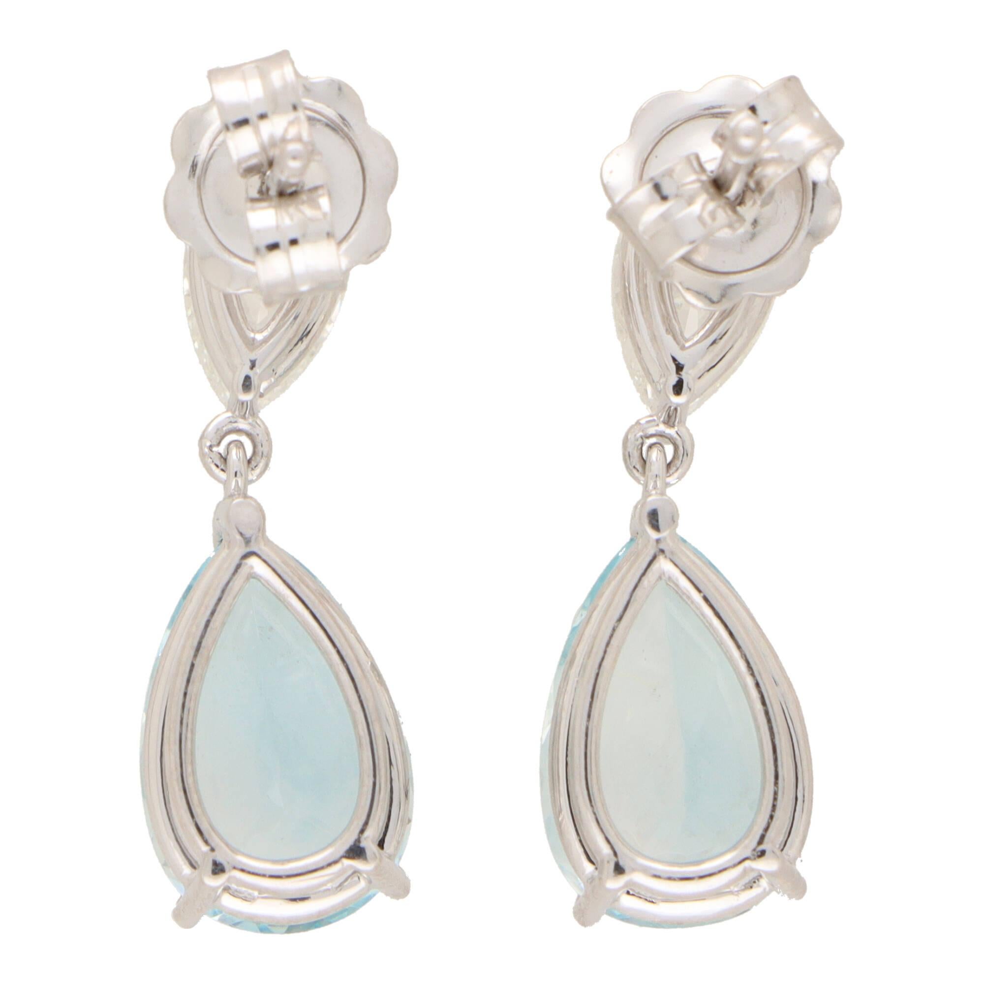  A beautiful pair of contemporary aquamarine and GIA certified diamond drop earrings set in platinum.

Each earring is firstly composed of a certified pear brilliant cut diamond which is three claw set securely. Descending from the diamond is a