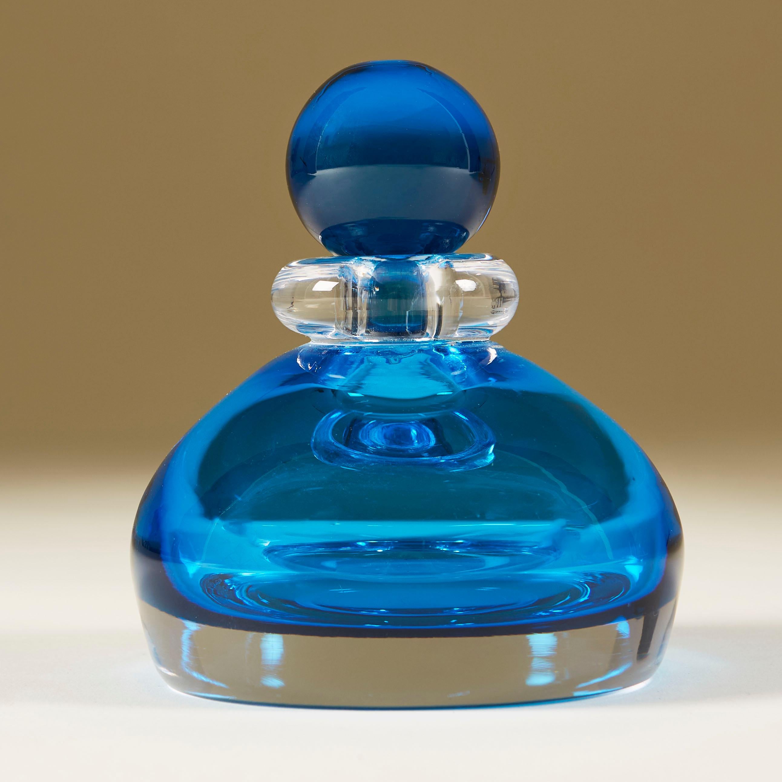 Rich aquamarine perfume bottle cased in clear Murano glass with clear glass collar and aqua marine ball stopper.