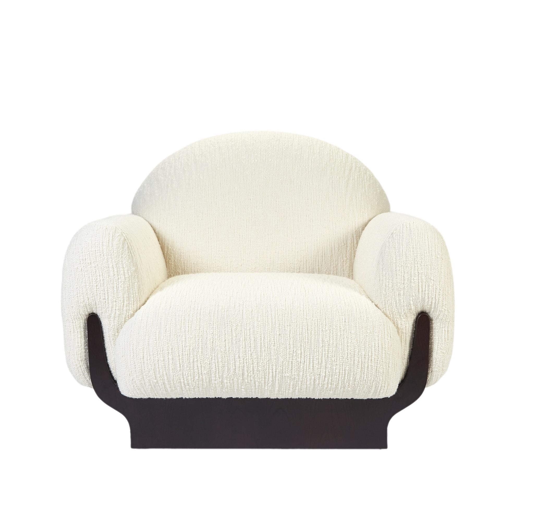 The seat is upholstered in high quality boucle fabric. The darkened wood structure provides strength and lightness to the piece.
Dimensions: Width 40.5” x depth 38.5” x height 33” x seat height 15.75”
Custom sizes and materials available. 
Made to