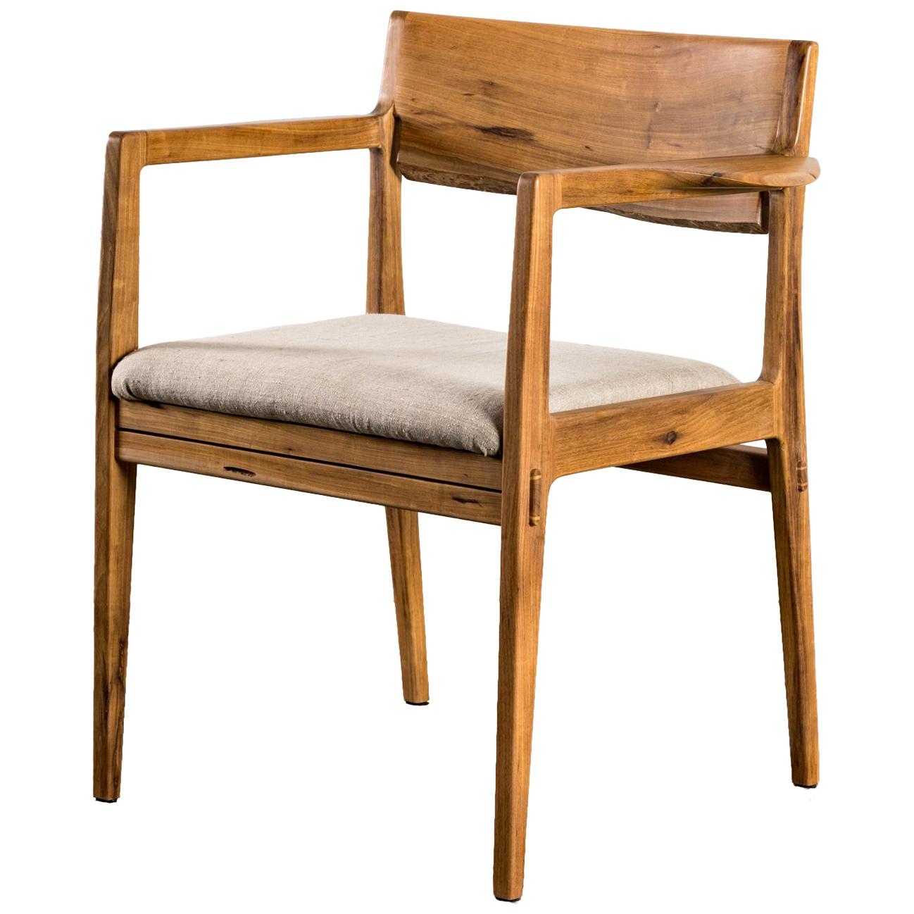Contemporary armchair made with reclaimed exotic tropical hardwood.
The seat is upholstered with linen.

Some of the featured details are the 'live edge' of the armchair's backrest wood and the well-designed arms.

It can be produced by demand in