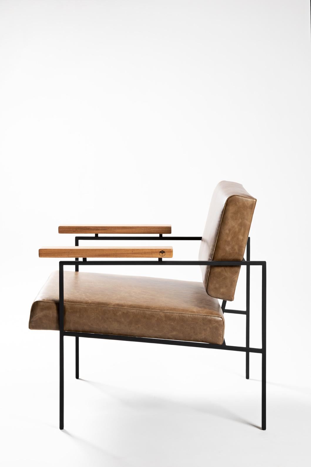 This award winning minimalist armchair 'Helena' designed by Samuel Lamas has an architectonic and geometric reasoning. The aim is to create a simple chair, with pure geometric shapes. Its square crossbars in solid iron create a perfect meeting point