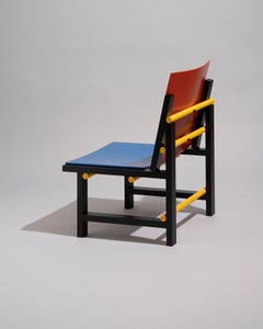 Modern contemporary armchair in red blue yellow black wood by Marc Morro