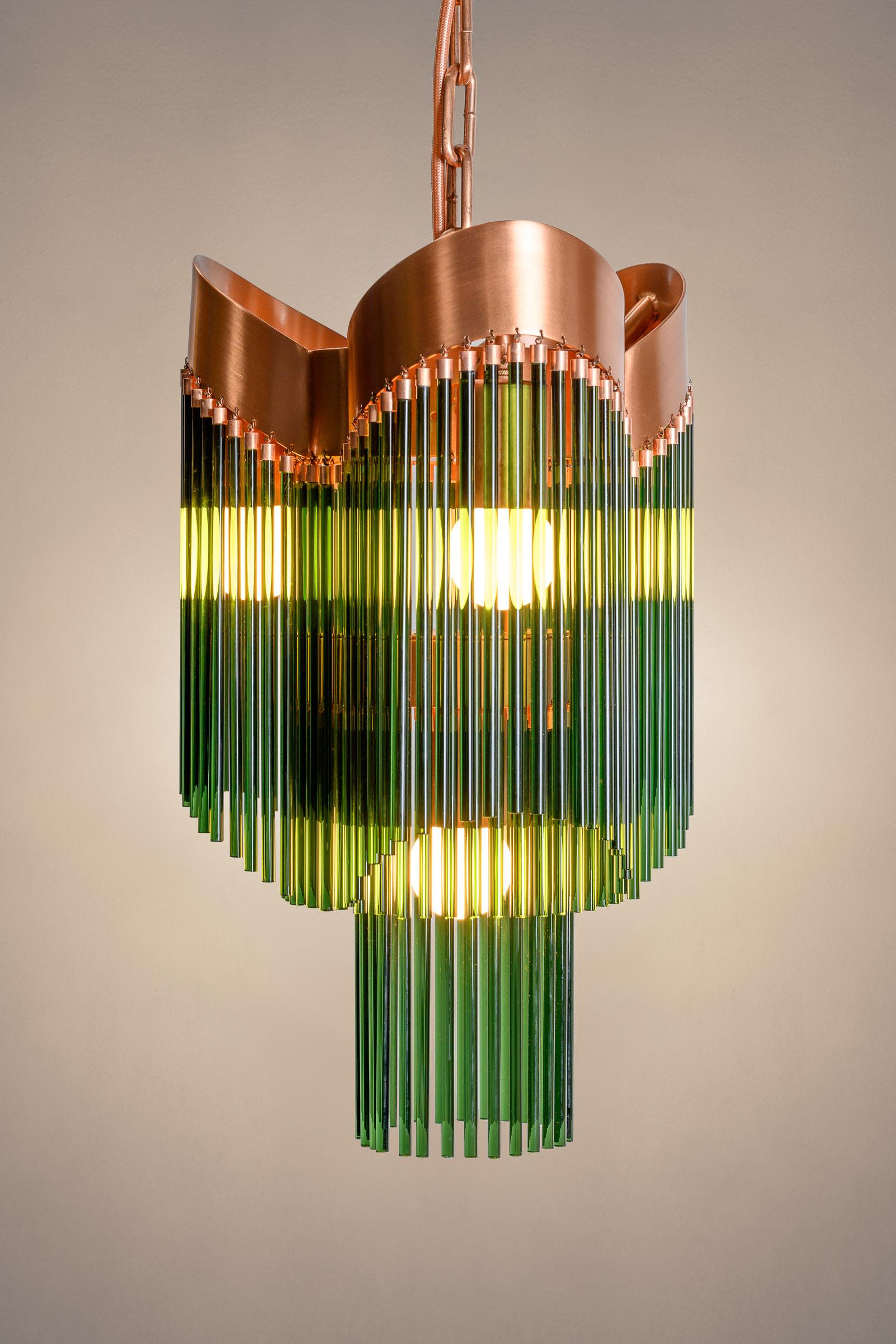The 'Aurea' edition, Copper & Emerald Green color way, was created by artist Carolina Fontoura Alzaga of Facaro Art Studio. 

Anchored by a two-tier, triple-crown base in brushed copper, this pendant strikes a harmonious balance of strength and