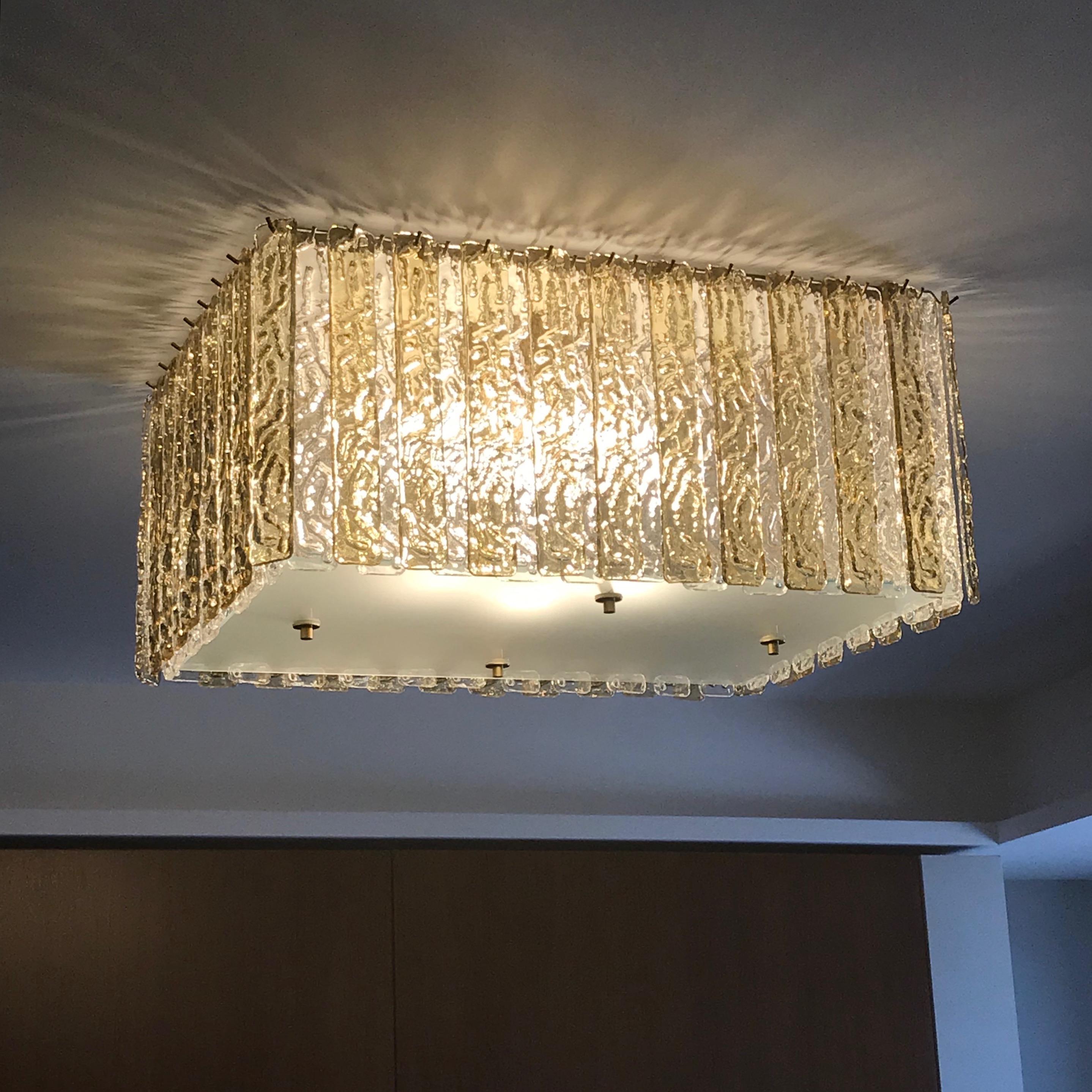 Bespoke Italian modern Art Deco design, entirely handcrafted in Italy, chandelier customizable as flush mounts or pendants, here with a brass structure in a geometric rectangular shape, highlighted by the decor of alternate plates in gold amber and