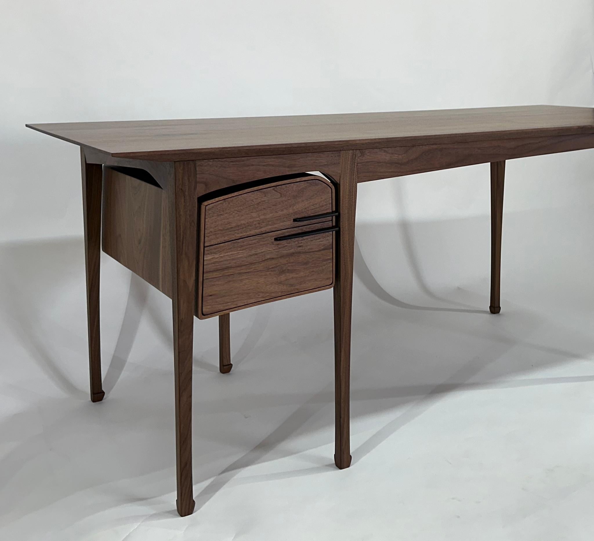 The Liu desk where whispers of art nouveau and chinese influence intertwine, captivating the eye with a delicate dance of motion.

shown: solid natural walnut with ebony pulls 

custom sizing available