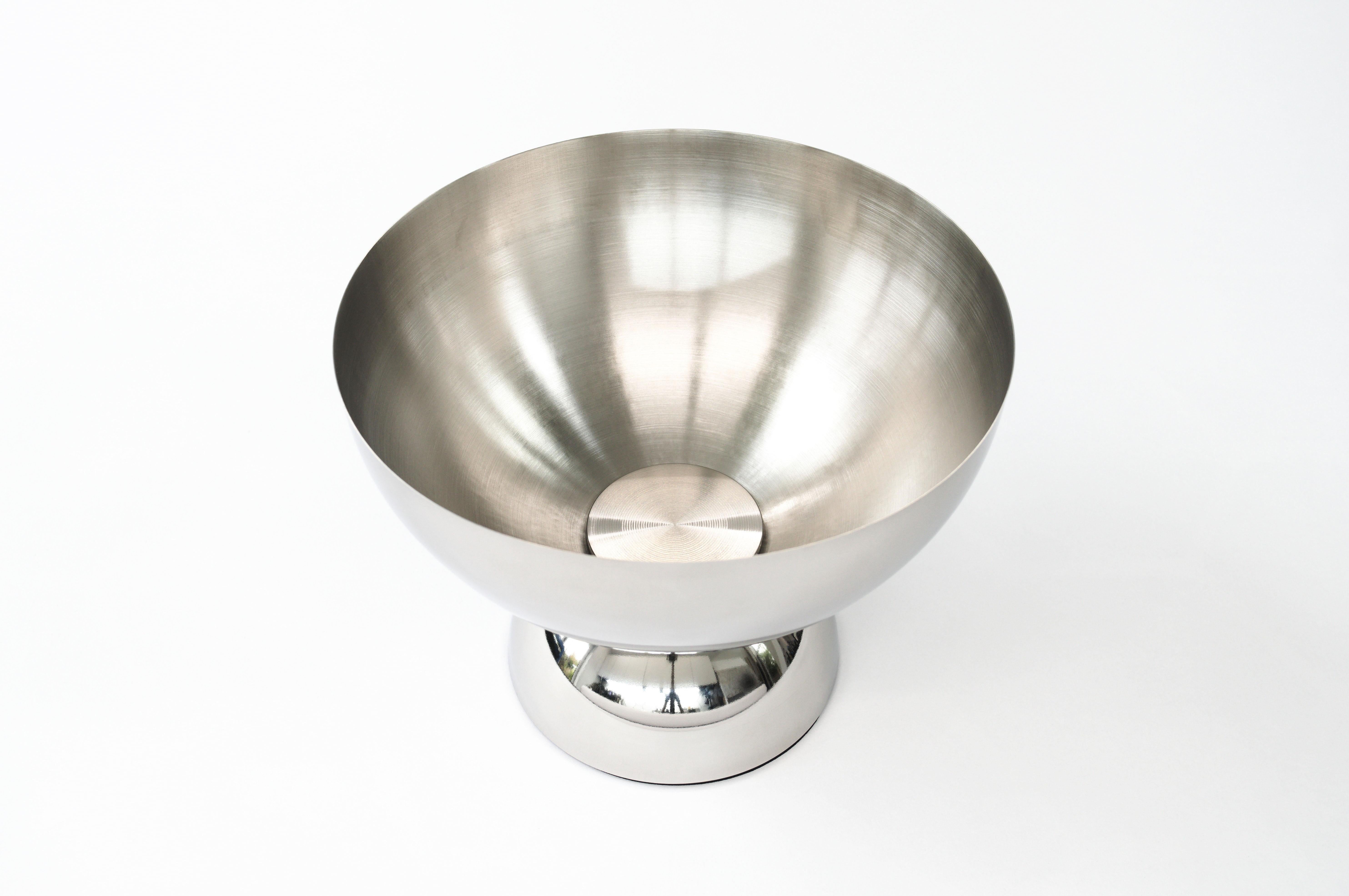 A futuristic bowl design made from polished stainless steel hemispheres, featuring a bushed finish on the inside and a wide diameter for use as a fruit bowl or decorative displays.

The bowl shares the same style with the Artemis Table and