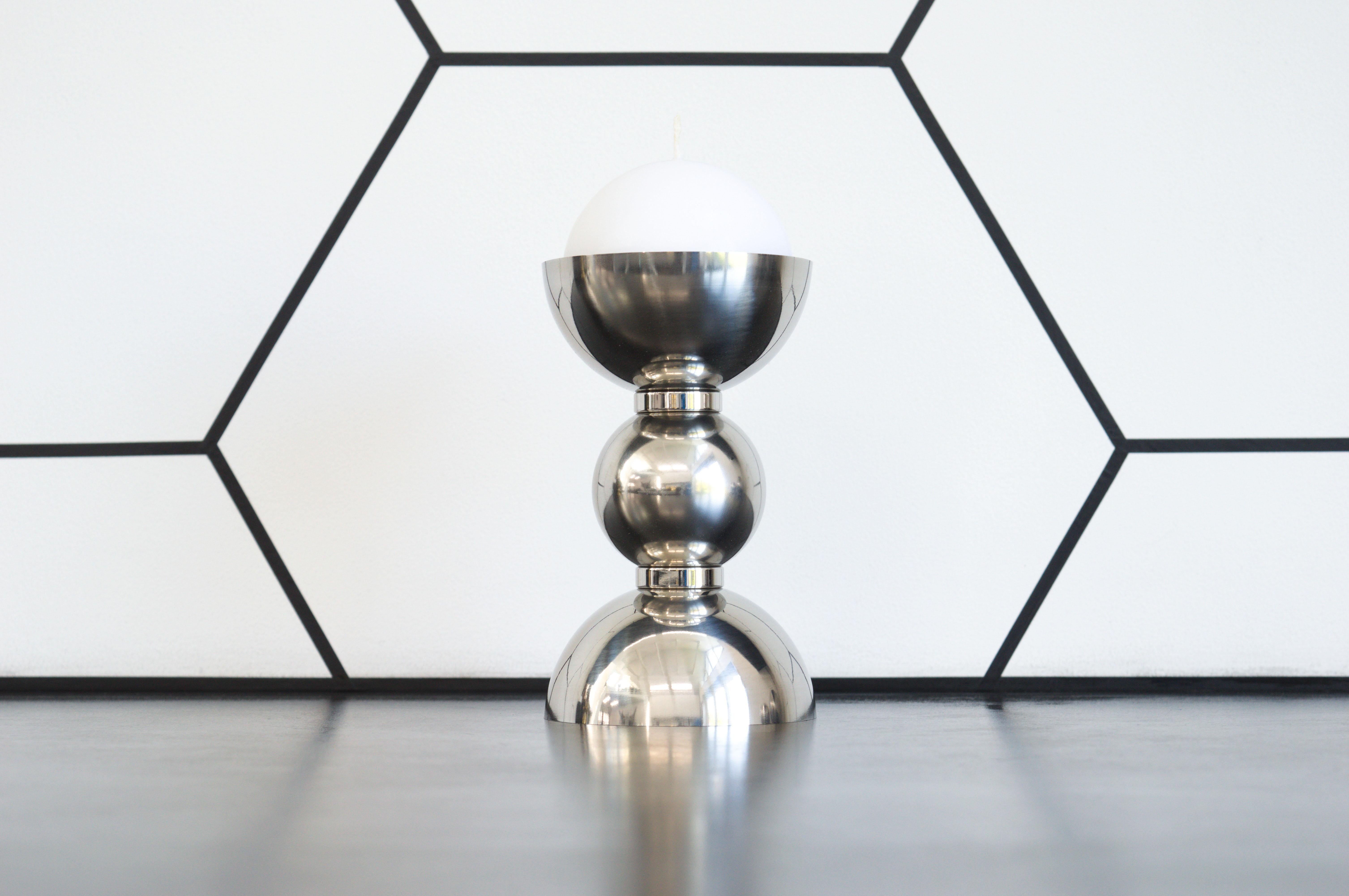 Contemporary candlestick created from polished stainless steel spheres and domes, sharing the form of the Artemis Table. The silver finish references SpaceX's stainless steel Starship design for transporting the Artemis astronauts to the Moon.

The