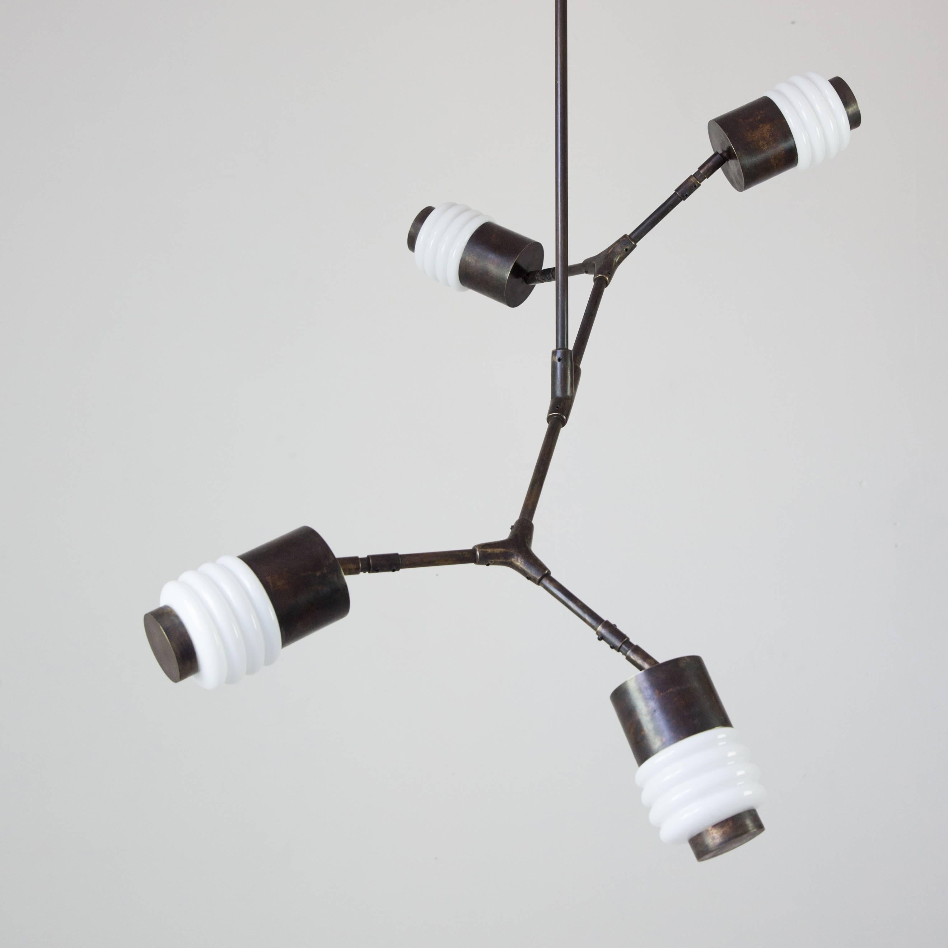 This articulated contemporary pendant lamp design is inspired by industrial electric components, using traditional metalworking techniques such as cast bronze and handmade brass parts.

 With handcrafted bronze connections by artisans, this pendant