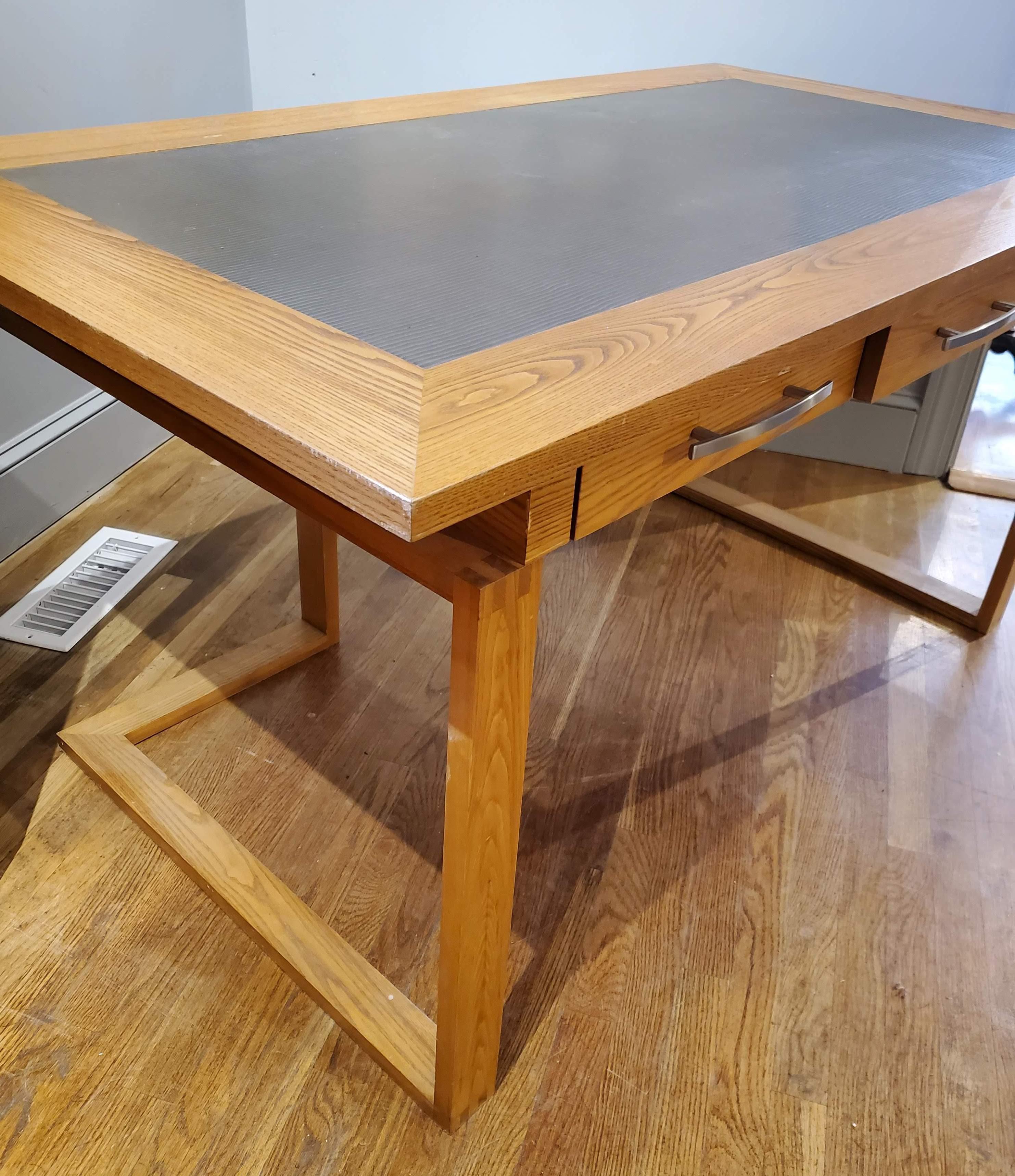 Add this gorgeous modern desk to your home office for a sophisticated look. Custom designed contemporary desk with three drawers made of honey colored figured ash. The paneled top is inset with gray faux leather over three drawers that have brushed