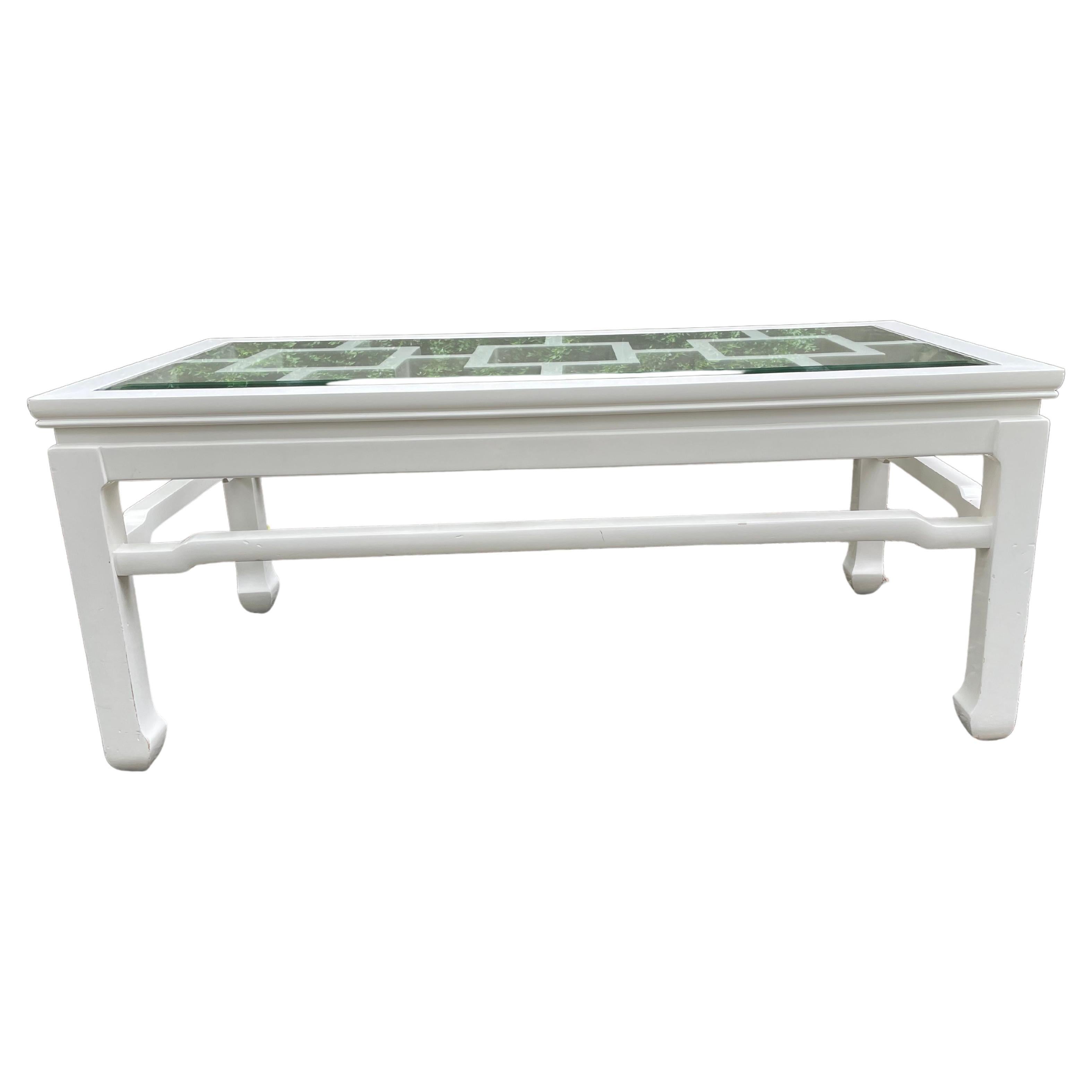 Very chic contemporary white lacquer coffee table with bevelled glass top having an Asian inspired design. The geometric motif visible through the top is marvelous.