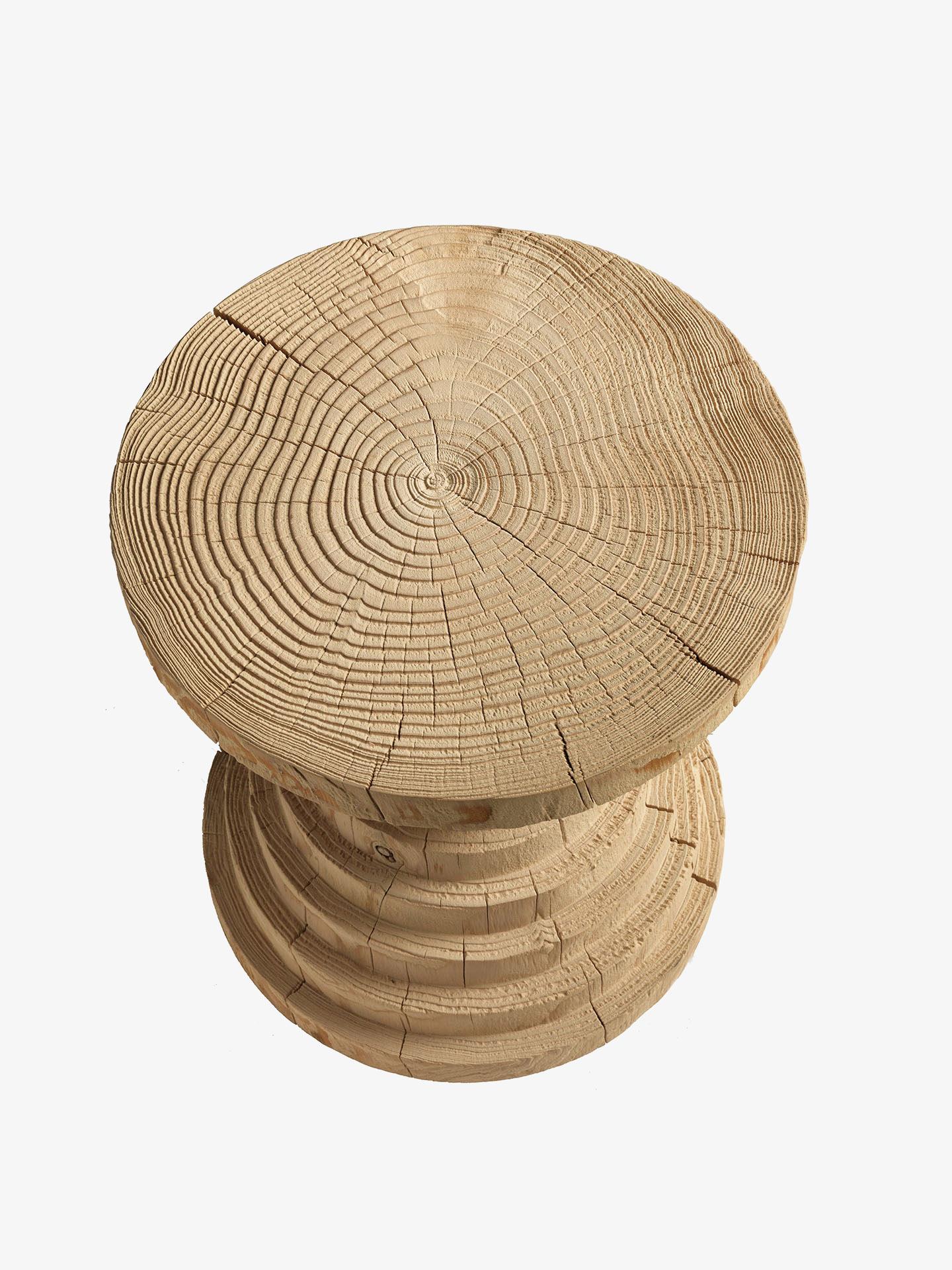 Stool made from a single block of scented cedar. It features many concentric layers that appear to be superimposed from large to small and from small to large. Designed by Michele de Lucchi.