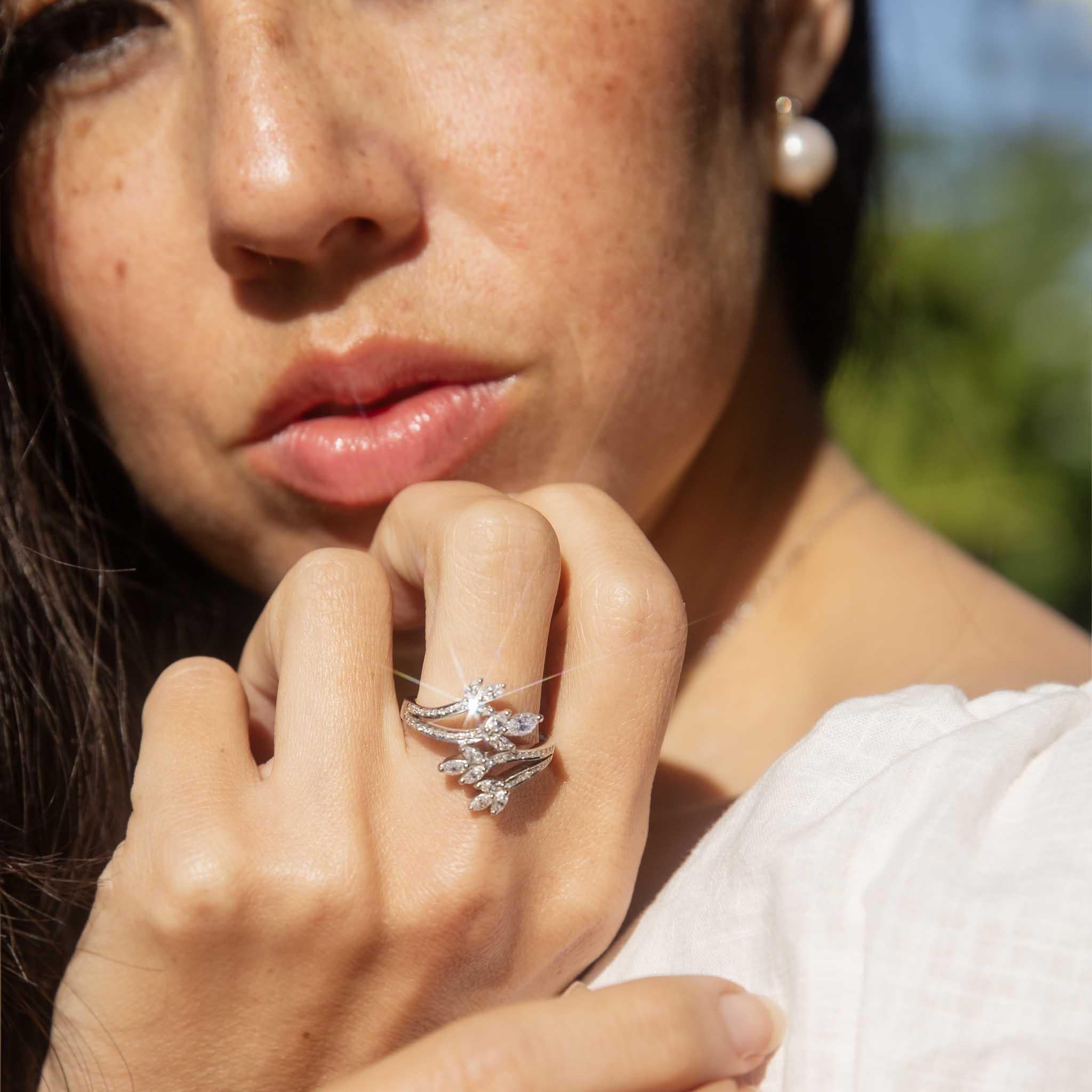 An exuberance of shimmer and light, nature's leaves embellished with diamonds that reach toward the sun.  Her crossover band crafted in 18 carat white gold is a stunningly bold beauty that embraces the wearer and invites the eye of others. We have