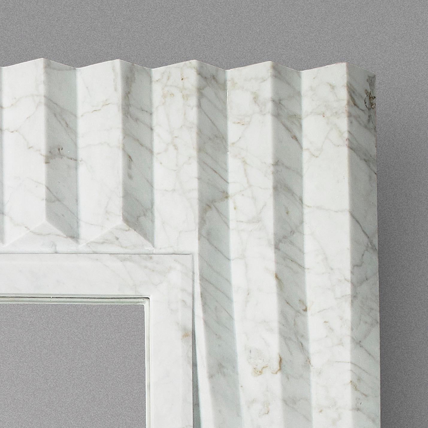 Cosulich Interiors in collaboration with Atelier Terrai: Italian bespoke mirror, entirely handcrafted in Italy, in white carrara marble with an elegant satin finish. This organic modern design is inspired by nature, earth and water, and speaks about