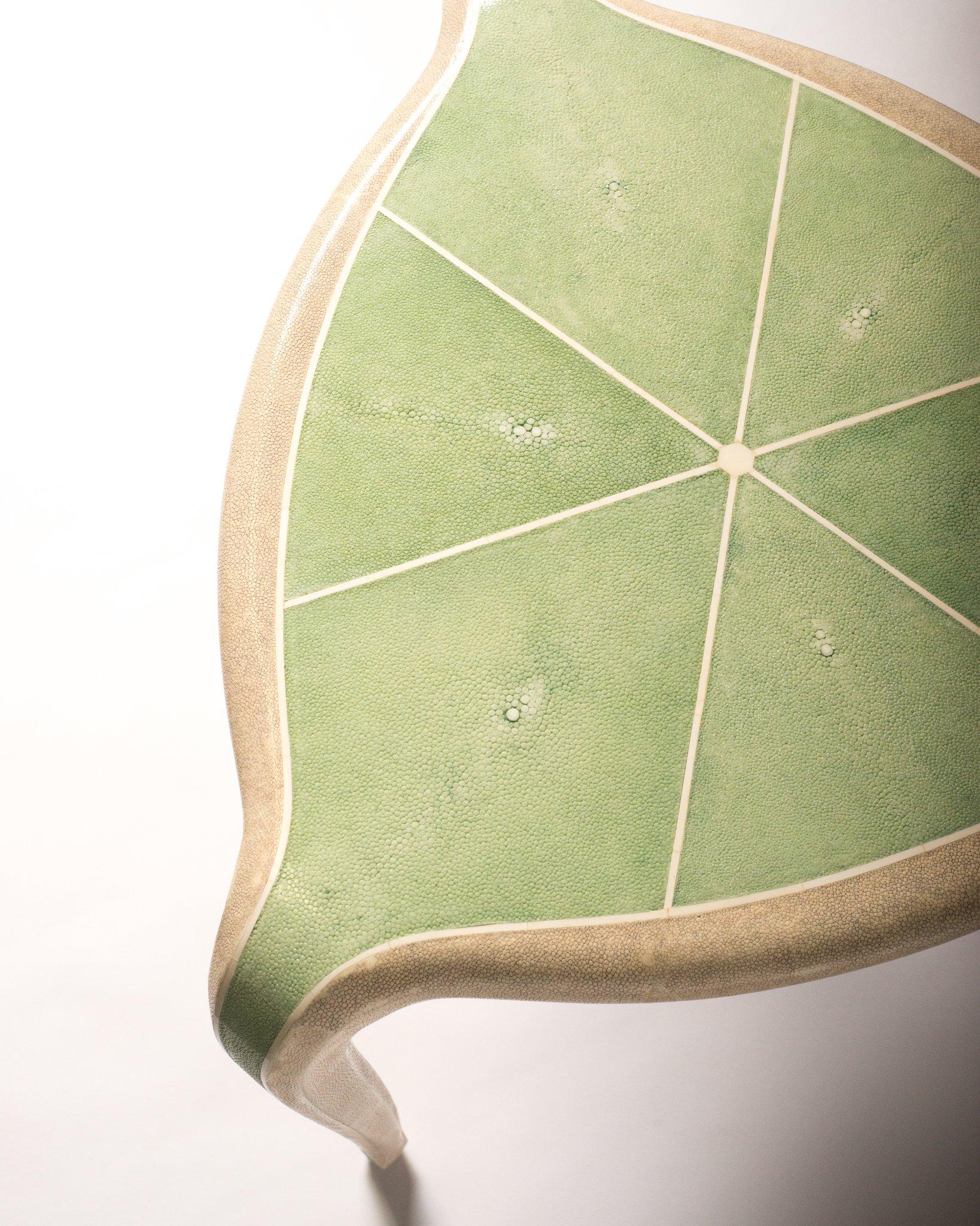 This tripod table is exquisitely crafted with a walnut veneer wood frame and completely covered in celadon green and crème shagreen and inlaid with bone. Organic curves and chamfered edges make a truly refined silhouette.