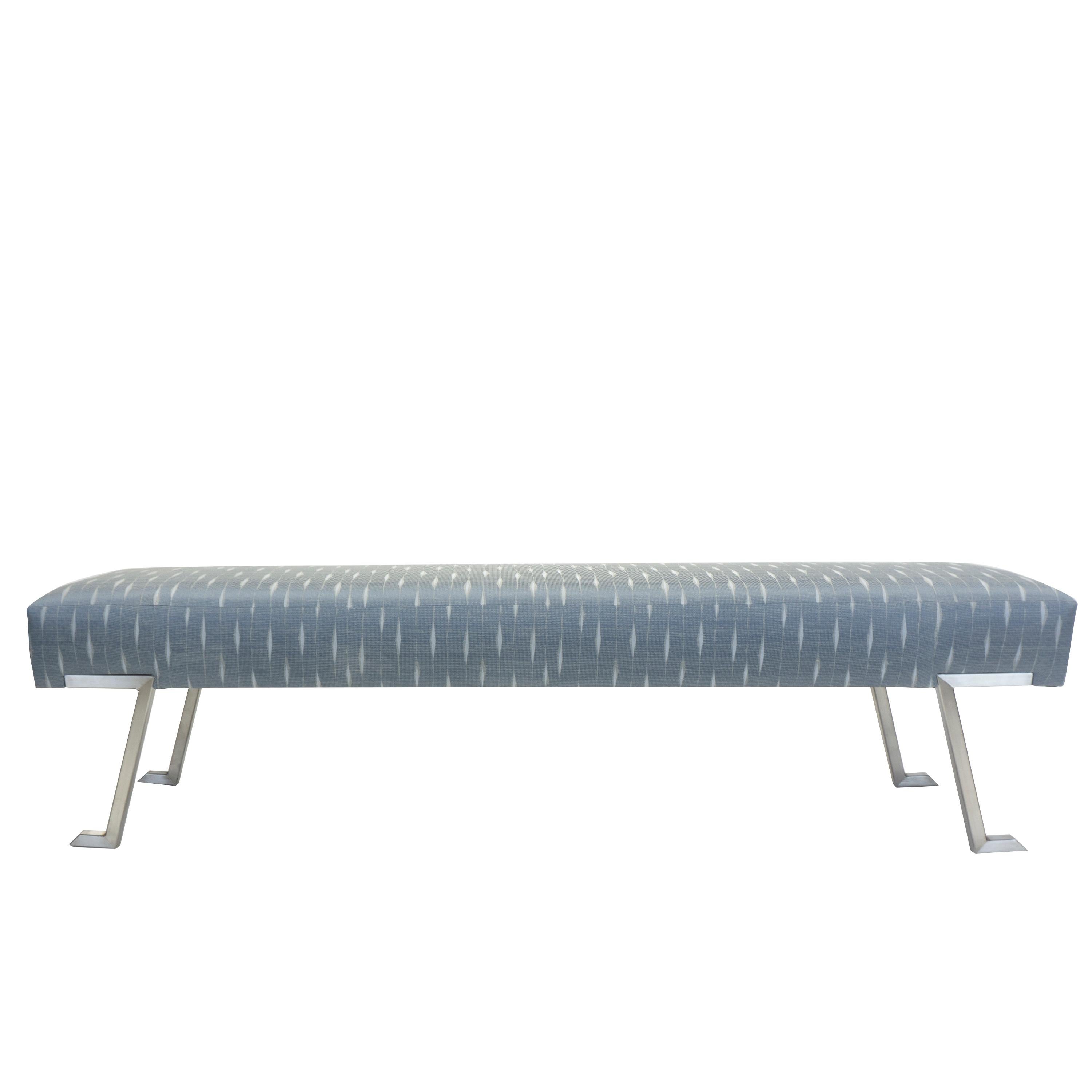 Our along the Nile bench is a contemporary backless bench with cushioned seating. The bench is supported by four satin nickel legs that shape like a Greek key pattern. This bench is built to order with custom size and fabric specifications upon