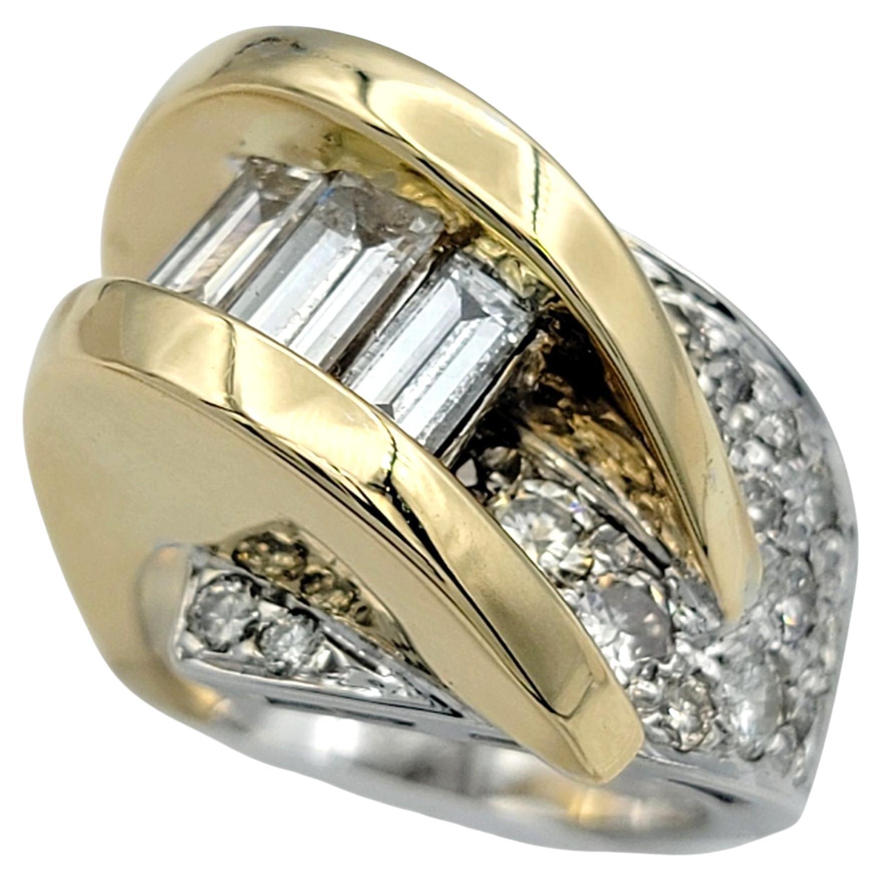 This bold and sophisticated diamond ring showcases a striking bypass design that seamlessly blends modern flair with timeless elegance. The flowing curves of 14 karat white and yellow gold intertwine gracefully, creating a sculptural silhouette that