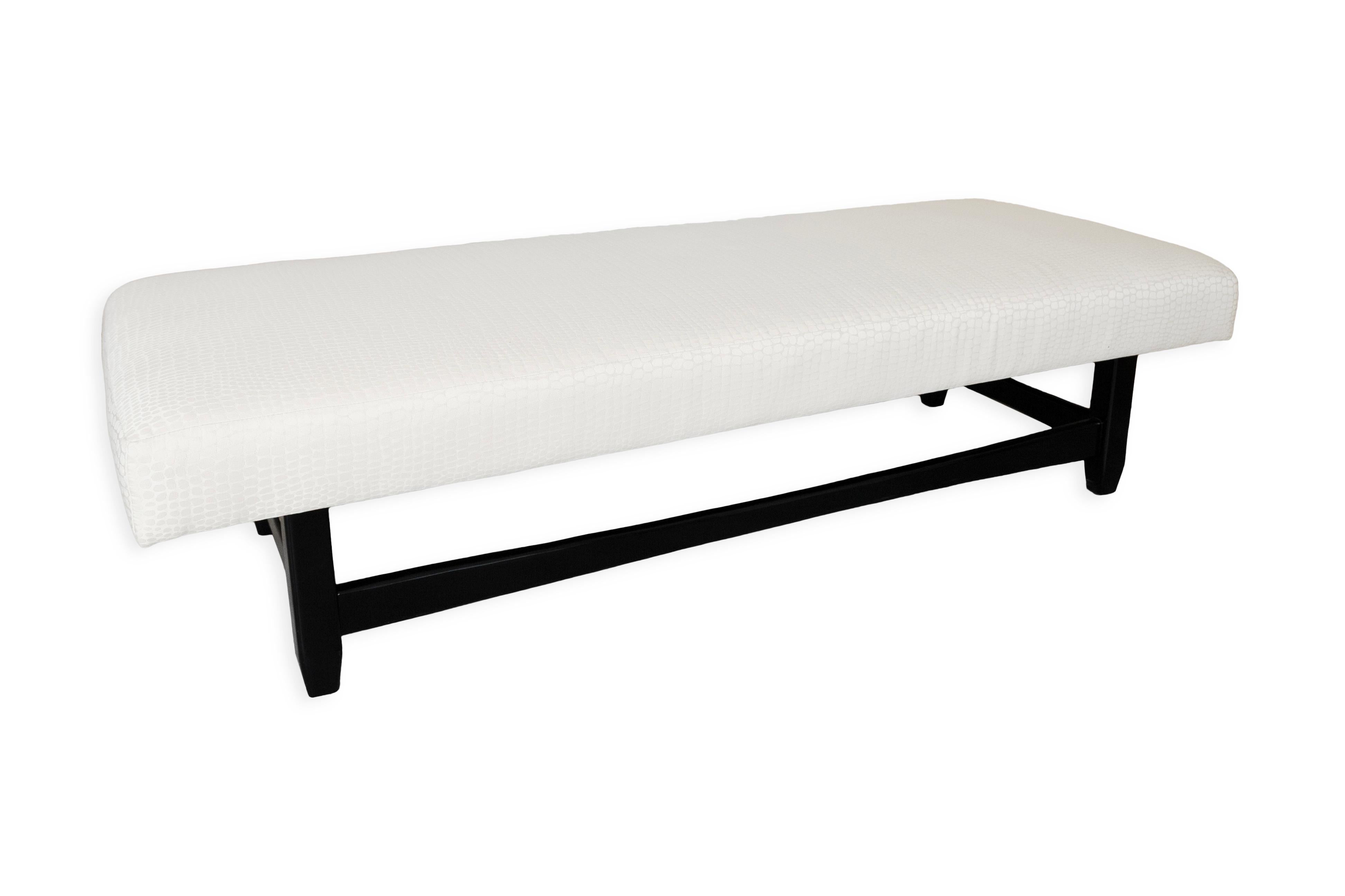 This is a beautiful contemporary bench made of black wood, featuring a white crocodile print upholstery. At first glance, the bench appears understated, but up close, the stunning crocodile pattern transforms your perception of it. The bench is low