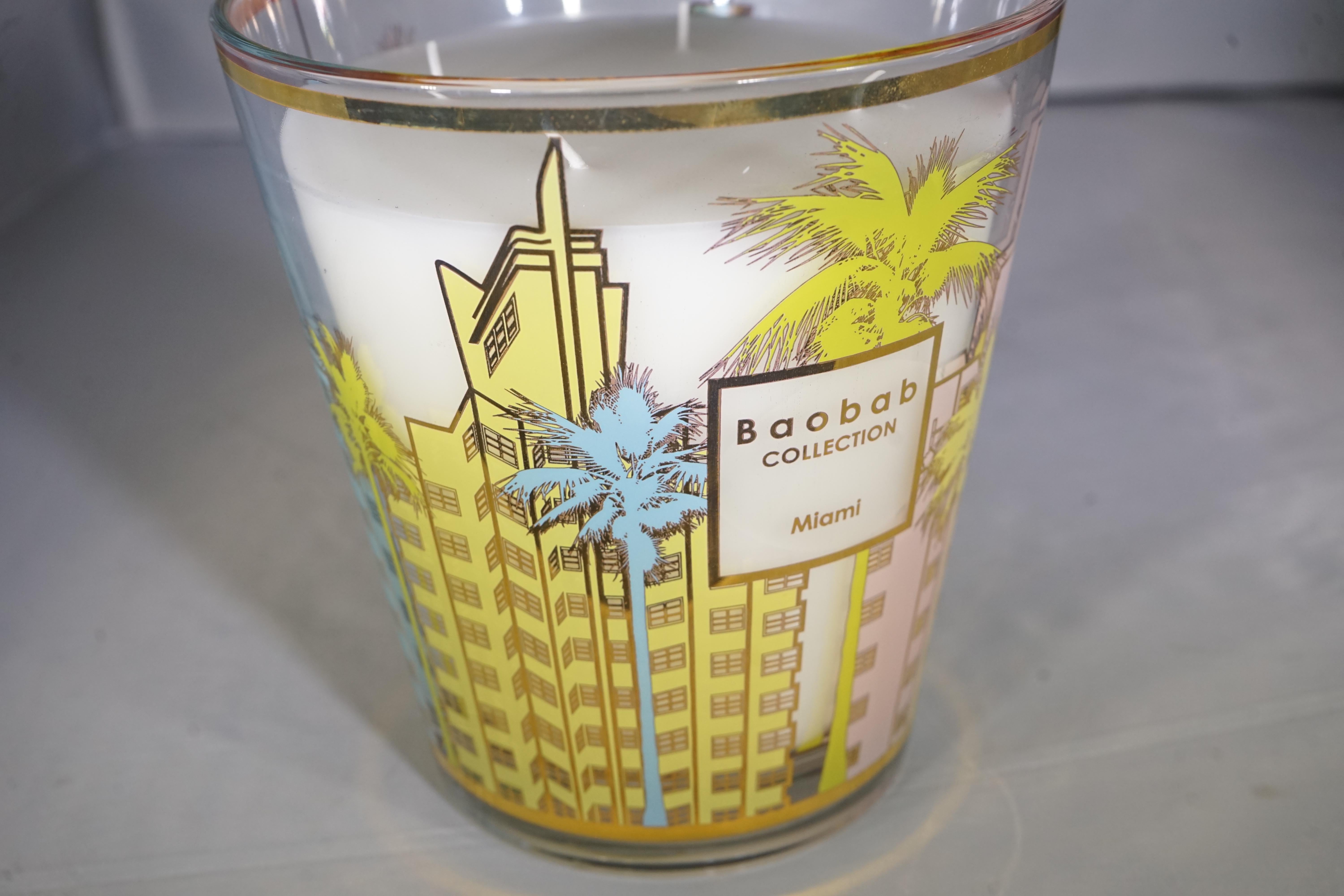 Contemporary Baobab collection luxury scented glass Miami candle with palm tree and multi-color Miami architectural design.