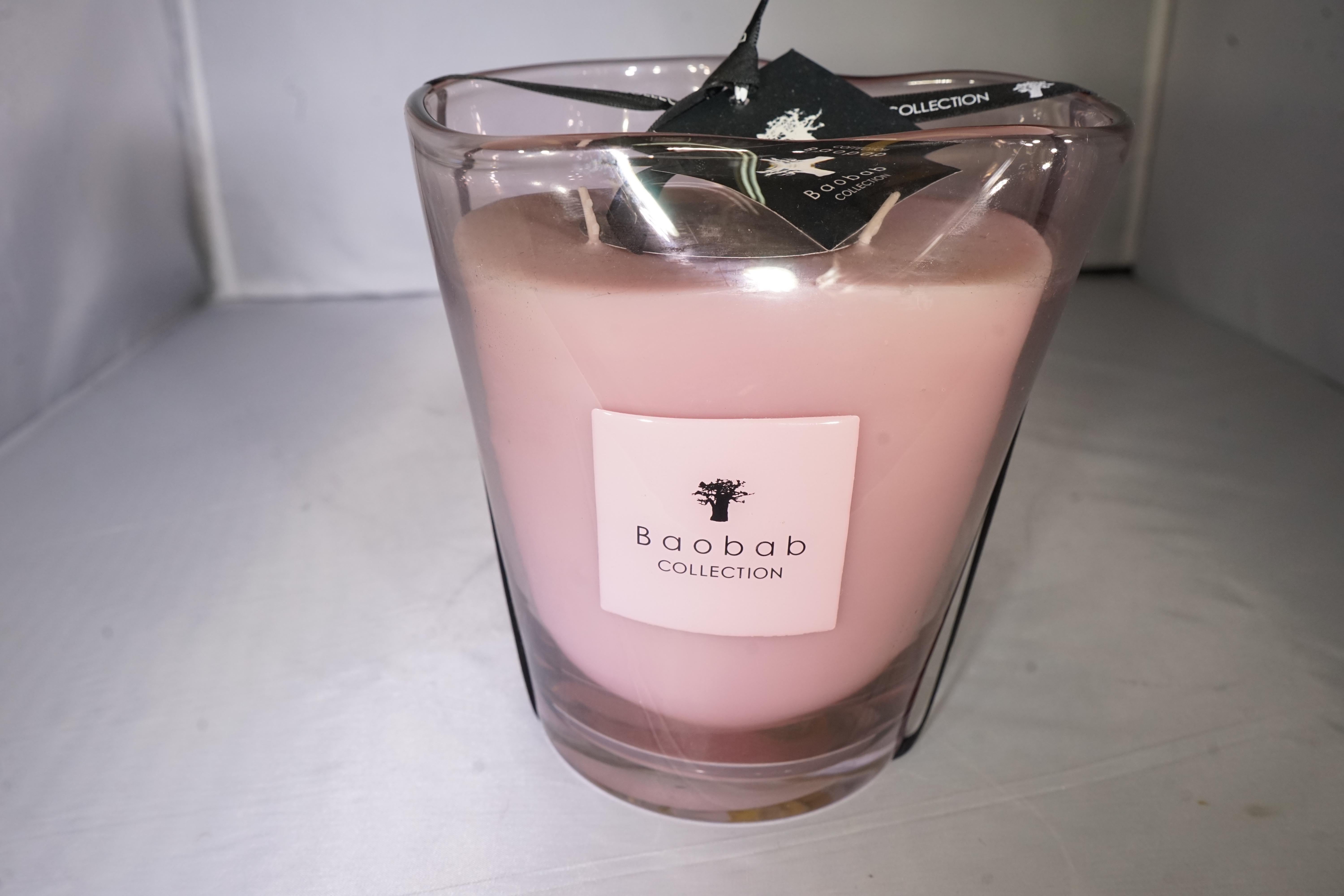 Contemporary Baobab Collection luxury scented pink candle with undulating glass.