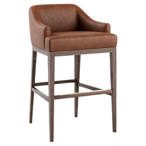 This stool stands out as a remarkable piece, featuring sleek lines, a curved back, and lower arms. Upholstered seat and back with a wooden structure, this exceptional design effortlessly integrates into both contemporary and sports bars. Available