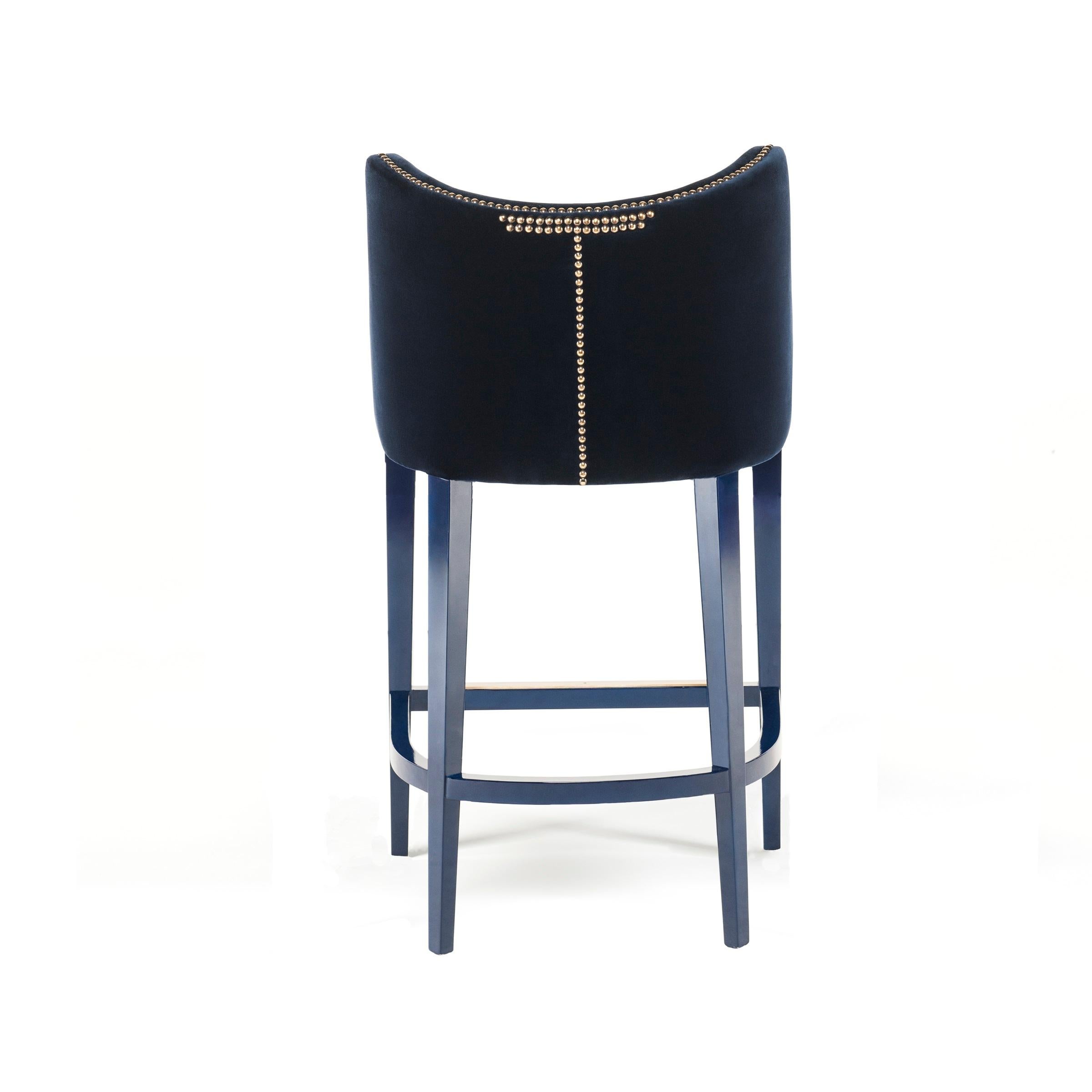 This barstool is the epitome of serenity inducing design. With an embracing Silhouette and luxurious deep seat, its sensuous curves and comfortable back perfectly adapt to the body. The nails adorning the curves and back of the pieces provide a