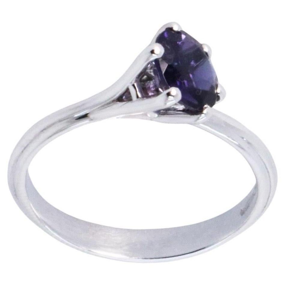 0.85 carats Iolite White Gold Asymmetric Cosmic Design Stackable Cocktail Ring.
The Egle ring is made of 18 karat white gold and features a round mixed cut natural iolite around 0.85 carats, diameter 6.4 mm. The total weight of the ring is 3.35