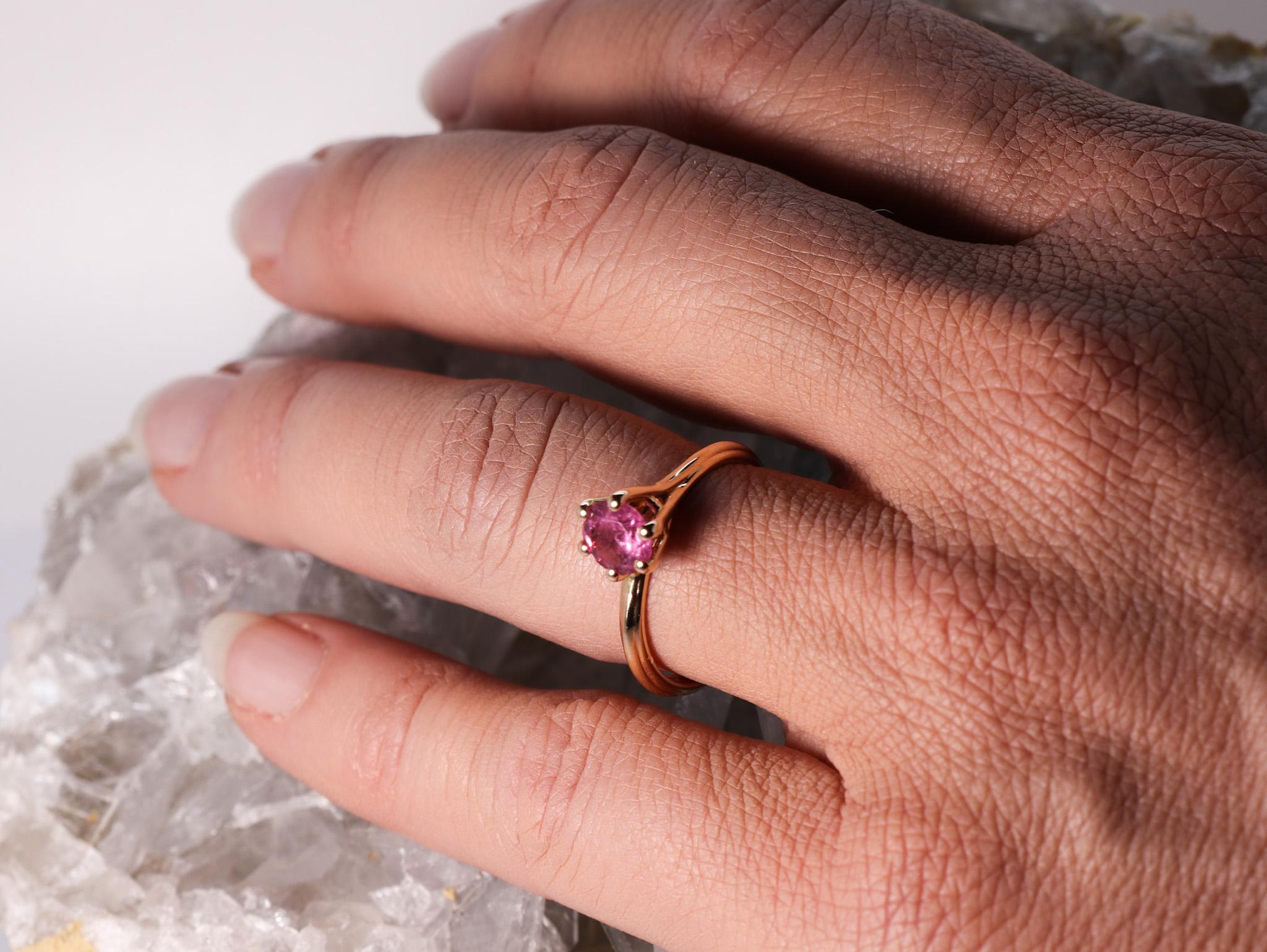 18K Rose Gold Asymmetric Cosmic Design Stackable Pink Tourmaline Cocktail  Ring.
The Egle ring is made of 18 karat rose gold and features a round mixed cut natural pink tourmaline around 0.8 carats, diameter 5.9 mm. The total weight of the ring is