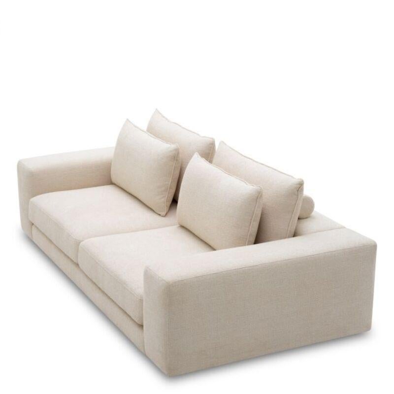 The beige fabric lounge sofa is a contemporary sofa that features wide armrests, deep cushions, and a Nuoro beige fabric finish that offers a soft appearance suitable for modern interiors.
It is comfortable padding and plush beige fabric make the