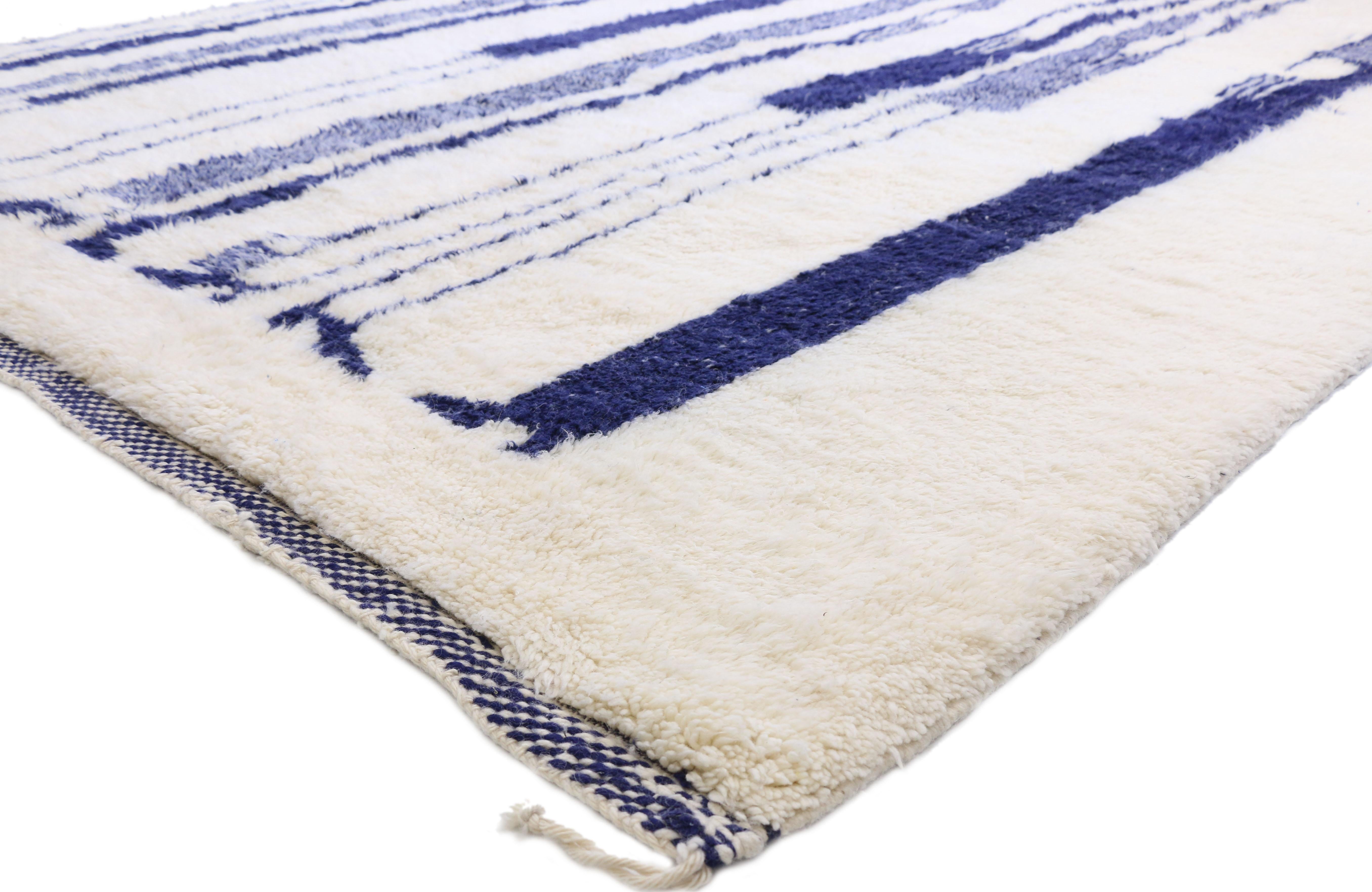 20812, contemporary Berber Moroccan rug with modern silhouette and Jazz Age style. This hand knotted wool contemporary Berber Moroccan rug features elongated silhouettes in a blue-scale palette against a solid ivory backdrop. With cool Jazz Age