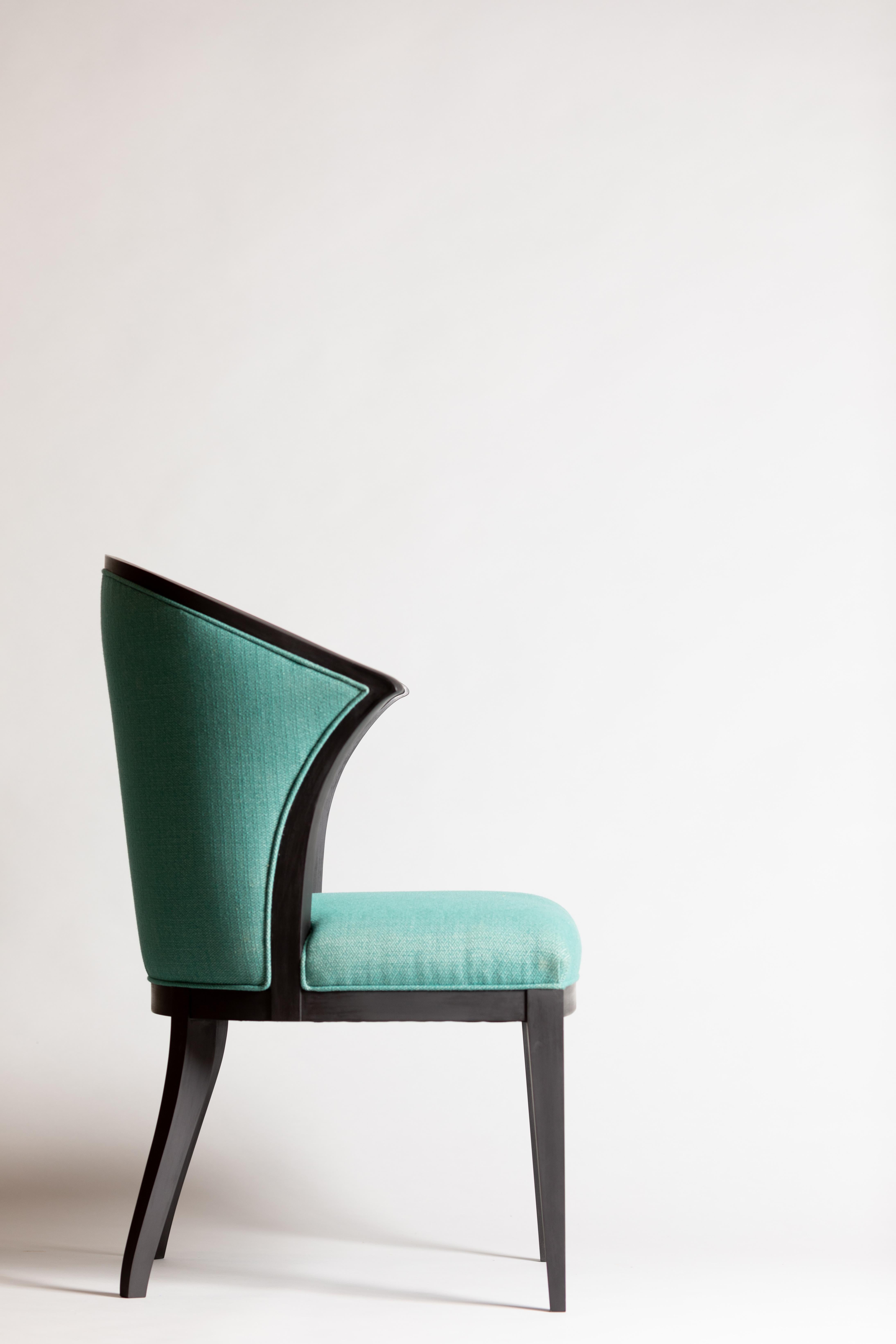 Contemporaine avec un clin d'œil à la tradition, cette chaise est robuste et classique. Les accoudoirs s'arrêtent avant l'avant de la chaise, ce qui la rend suffisamment confortable pour faire partie d'un salon, mais aussi pratique comme chaise de