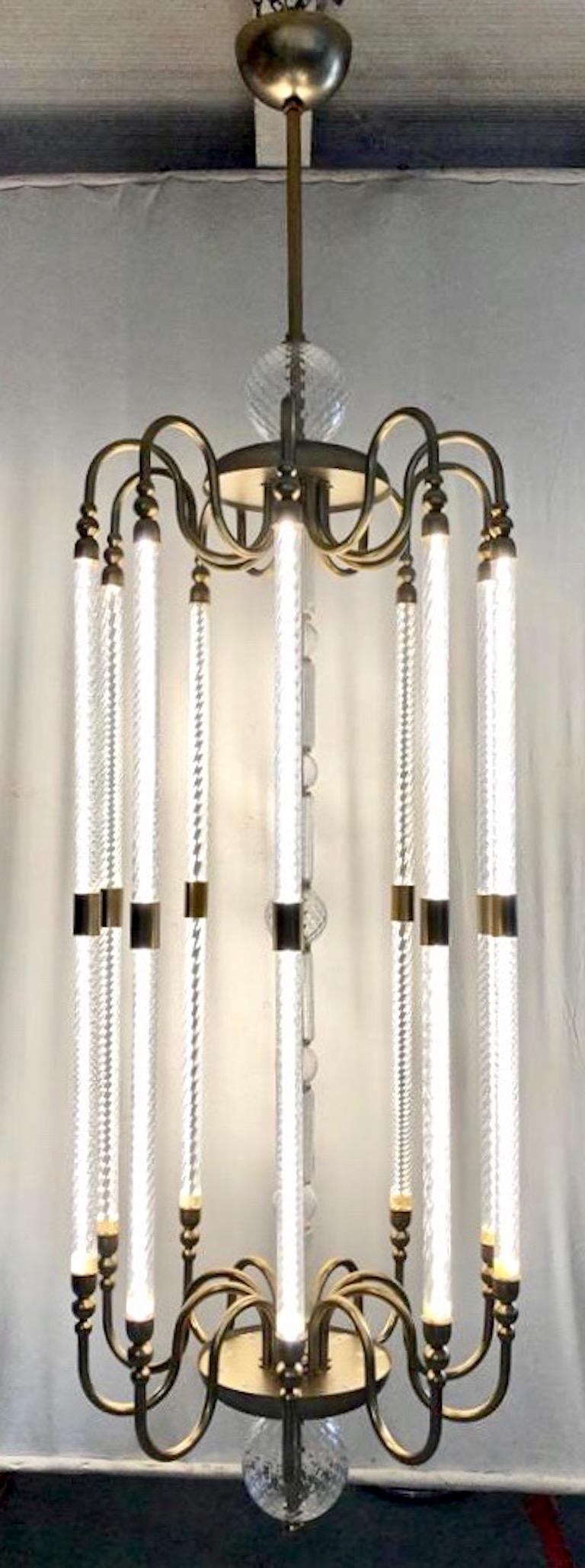 A modern creation by Cosulich Interiors & Antiques with an Art Deco flair, entirely hand made in Italy. This exclusive item is customizable in sizes and finishes. The light and open organic design represents a stylized lantern, the handcrafted metal