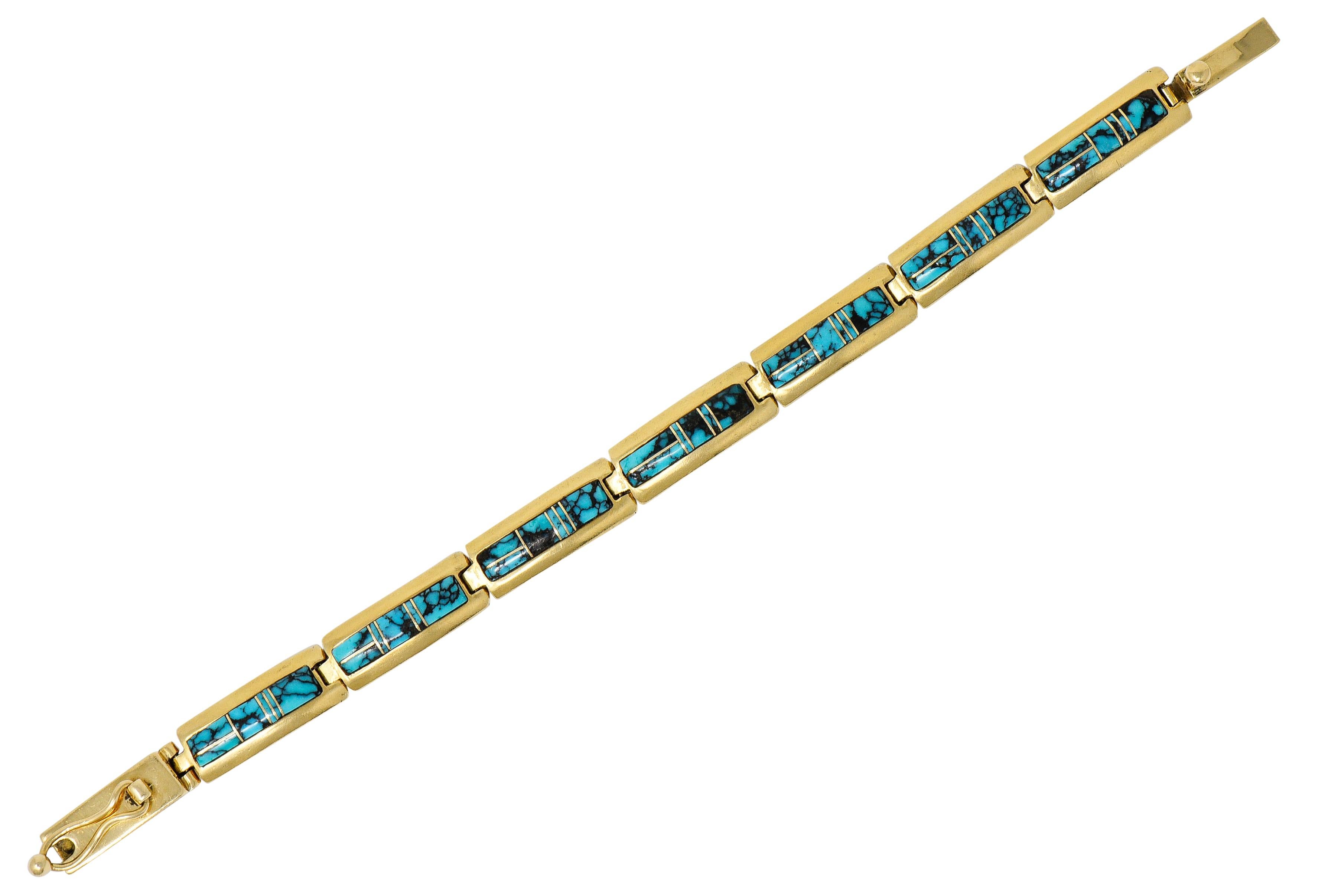 Bracelet is comprised of rectangular links inlaid with turquoise

Opaque and greenish-blue in color with black matrix veining throughout

Turquoise is accented by polished gold lines forming a geometric motif

Completed by a concealed clasp with a