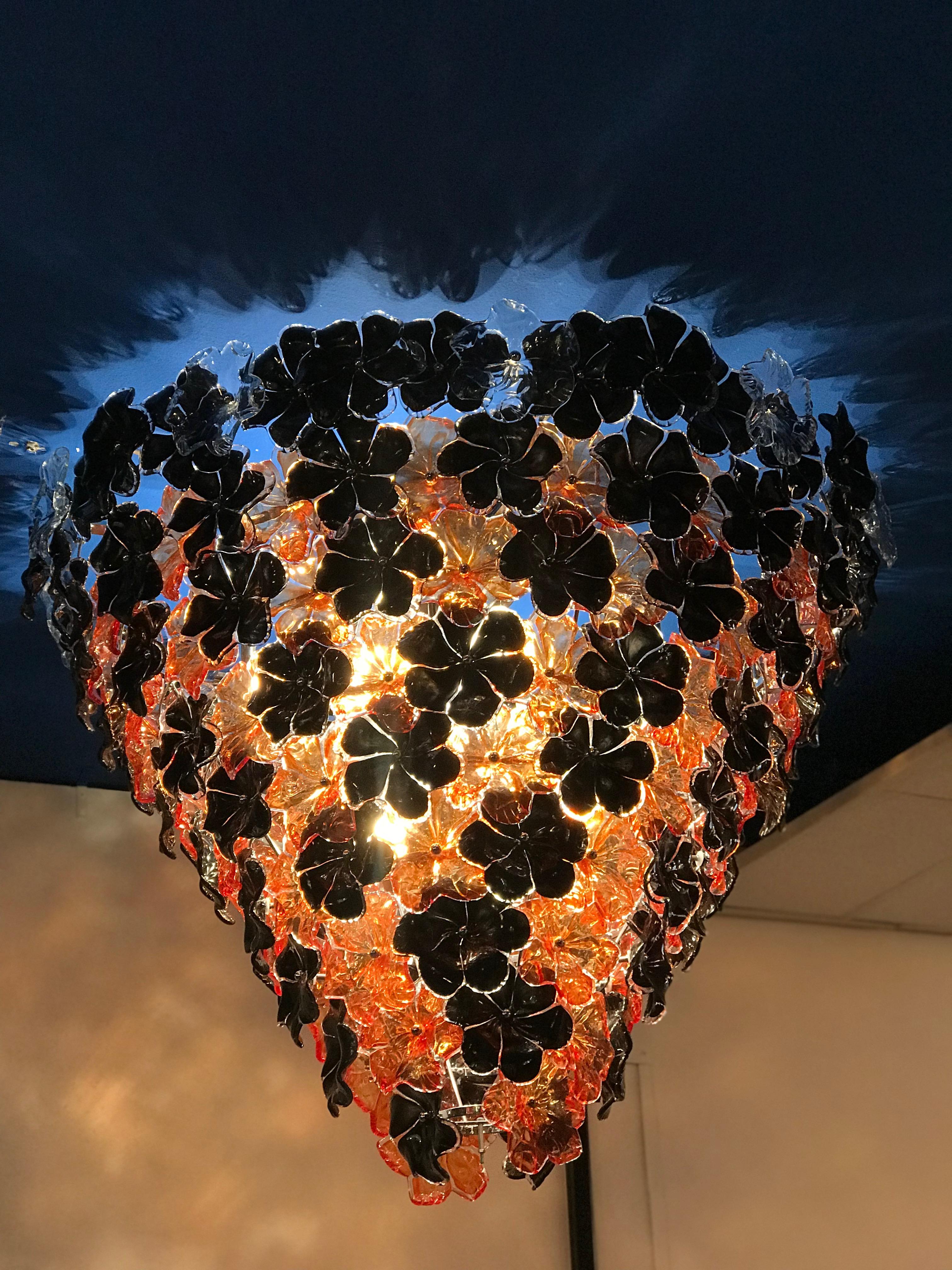 Striking contemporary Murano glass chandelier composed by dozens black and orange hand blown flowers by Galleria Veneziani.
Available also a pair.