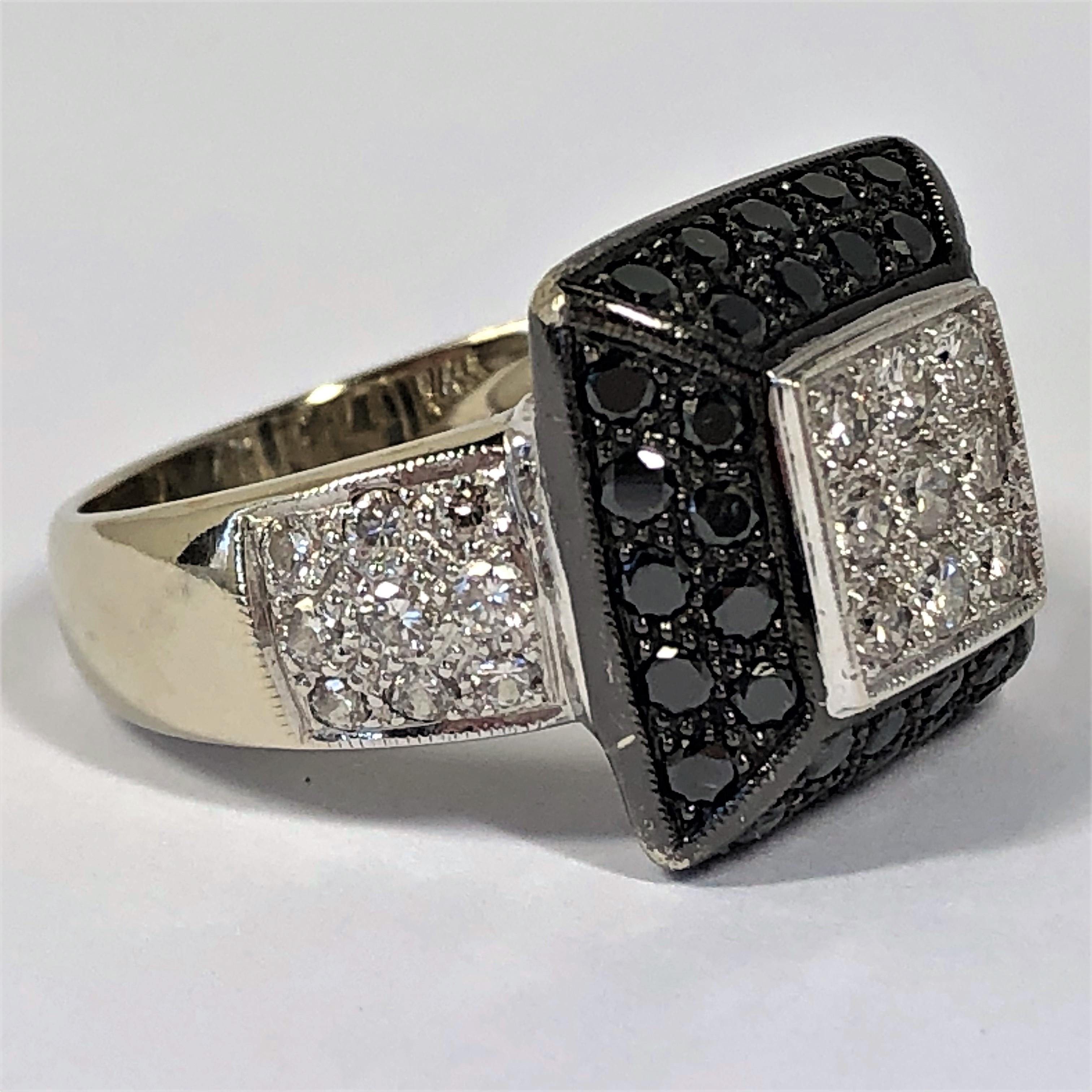 This contemporary 14K White Gold ring is set with 36 black diamonds weighing an approximate total of 2.00CT and with 27 round brilliant cut diamonds weighing an approximate total of 1.00CT of overall G/H Color and VS1 Clarity. The decorative center