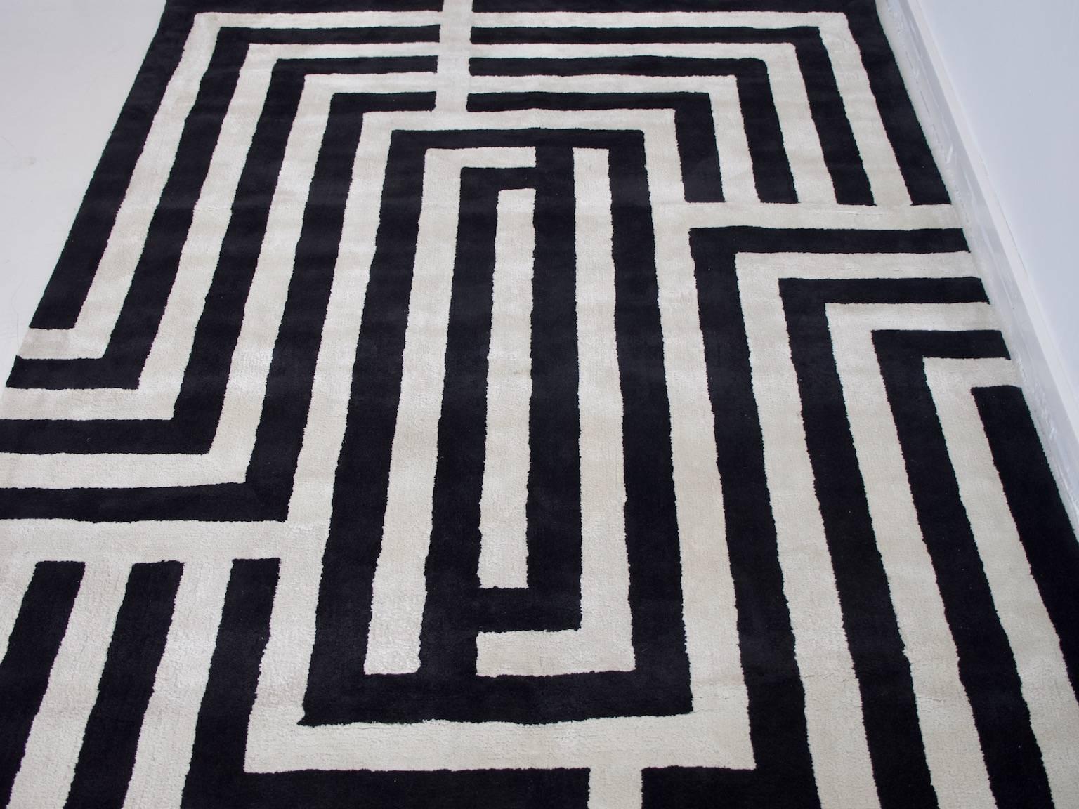 Contemporary wool rug with geometric black and white lines. Great addition to a modern living room.