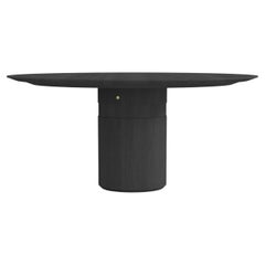 Contemporary round dining table, black ash wood, central leg, Belgian design