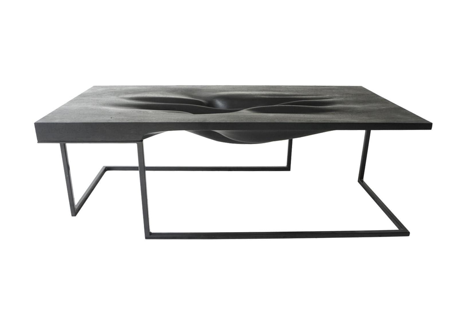 Carved ebonized coffee table by Vincent Pocsik.

Ebonized carved walnut with black metal base.

Vincent Pocsik finds the balance between old and new fabrication techniques working in conjunction to find an anatomical form that creates its own
