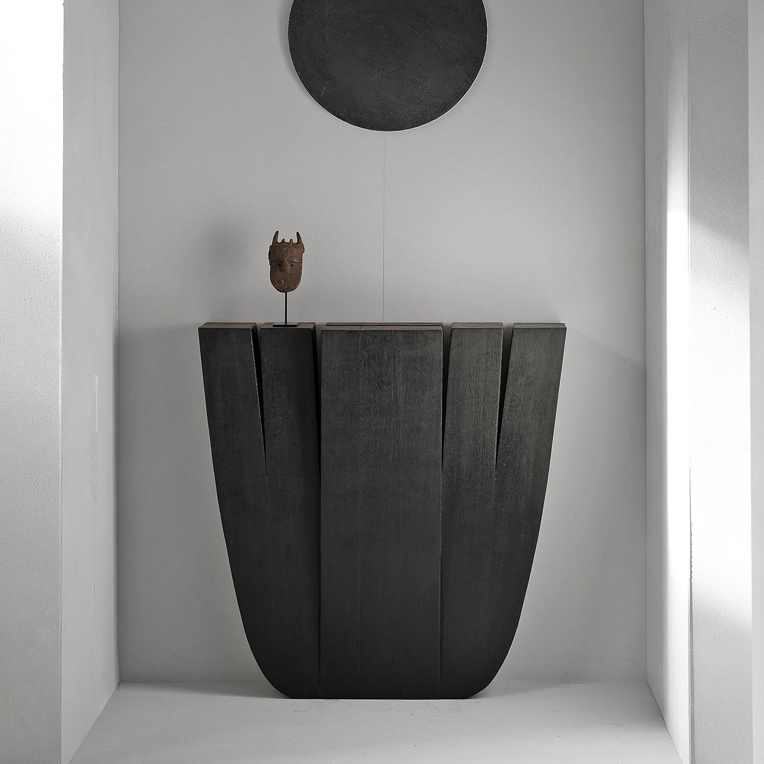 Contemporary black console in iroko wood - hallway table by Arno Declercq

Dimensions:
90 cm L x 25 cm W x 90 cm H
35.5” L x 9.8” W x 35.5” H

Material: Iroko wood

Made by hand, in Belgium.

Arno Declercq
Belgian designer and art dealer