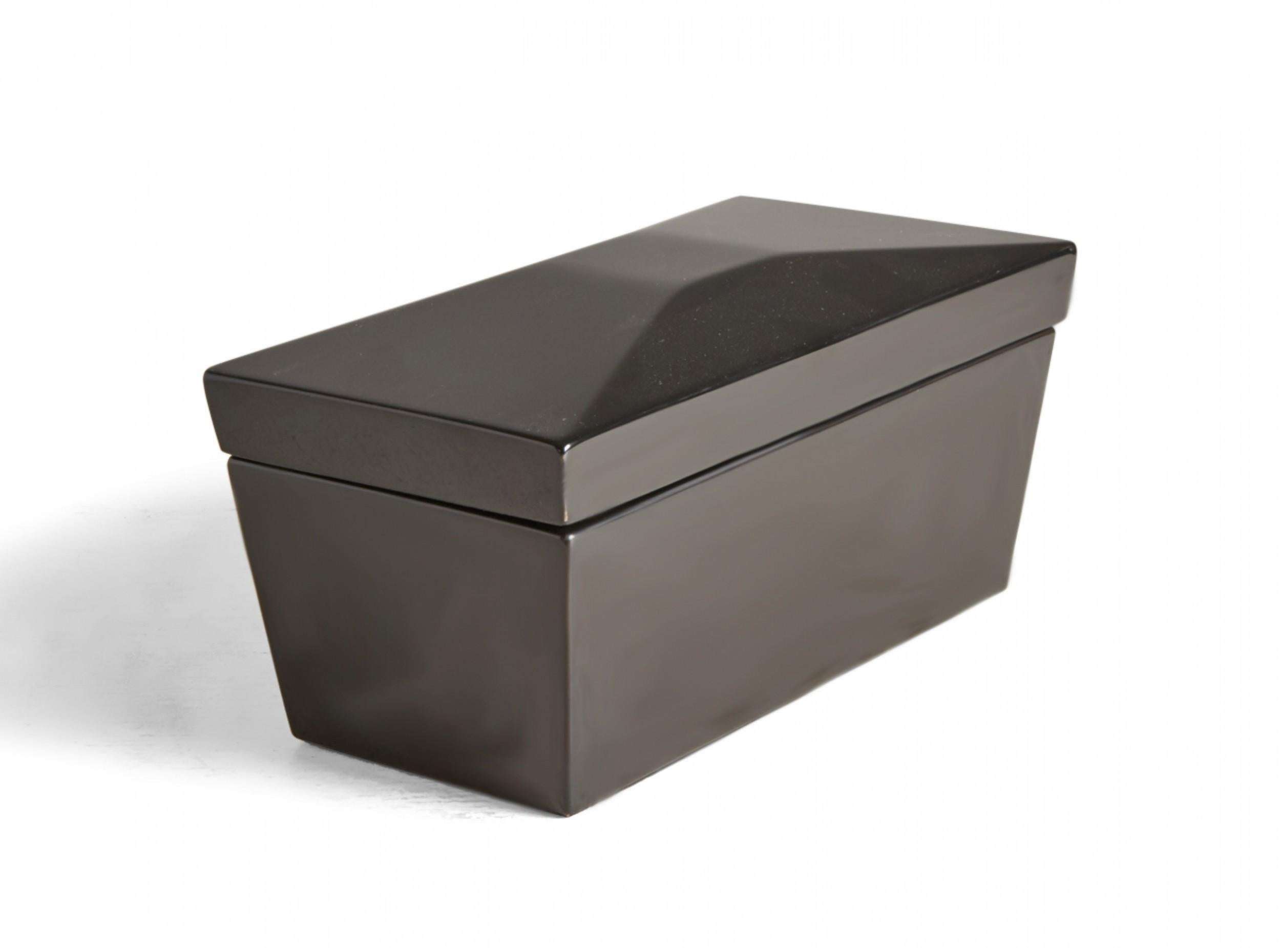 Contemporary decorative wooden box with a black lacquer finish, a rectangular profile with faceted lid and tapered sides, and a brass-hinged lid that opens to reveal two interior compartments covered with black lacquered wooden square lids with