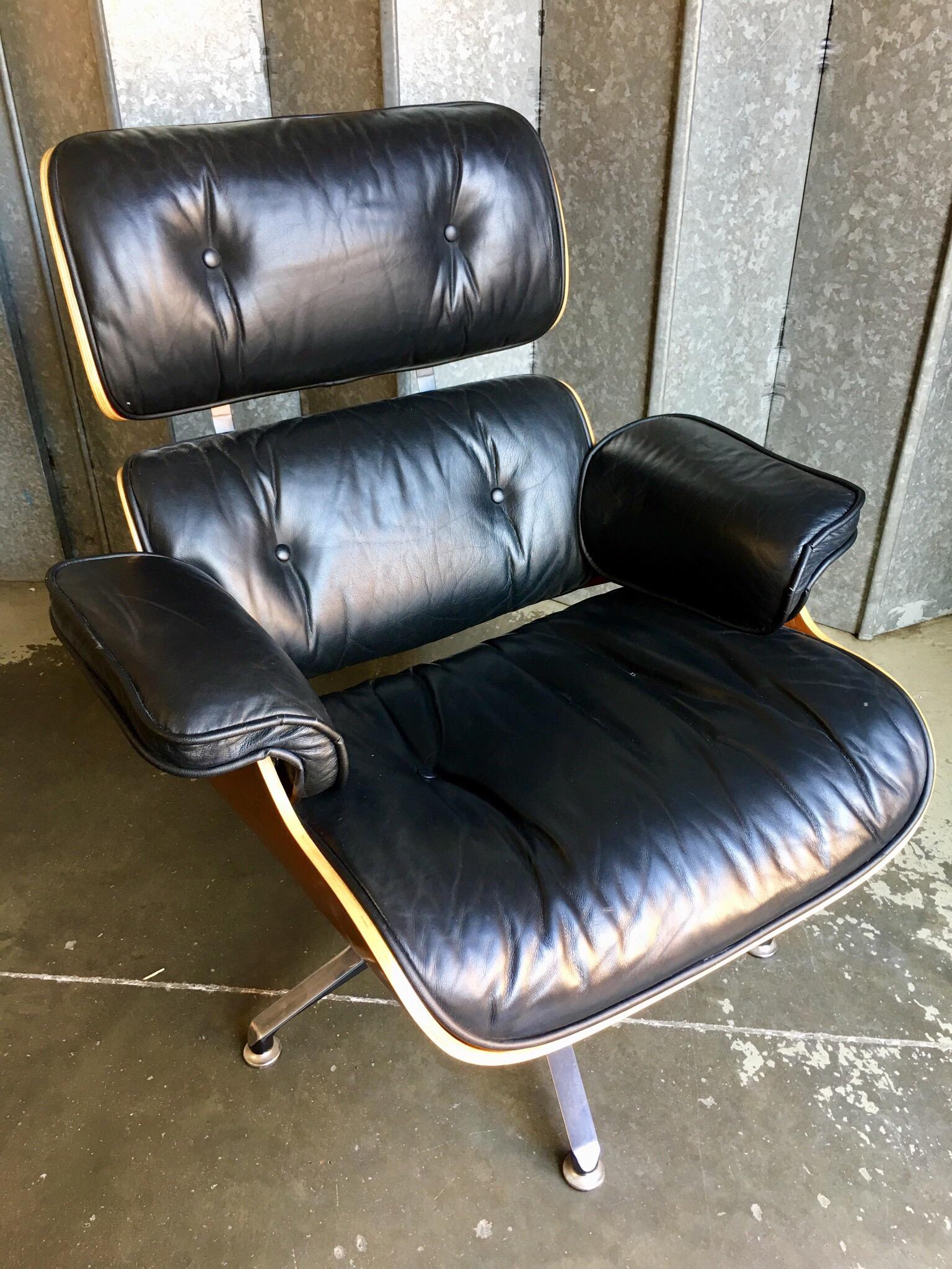 Leather Contemporary black leather and plywood lounger with matching footstool