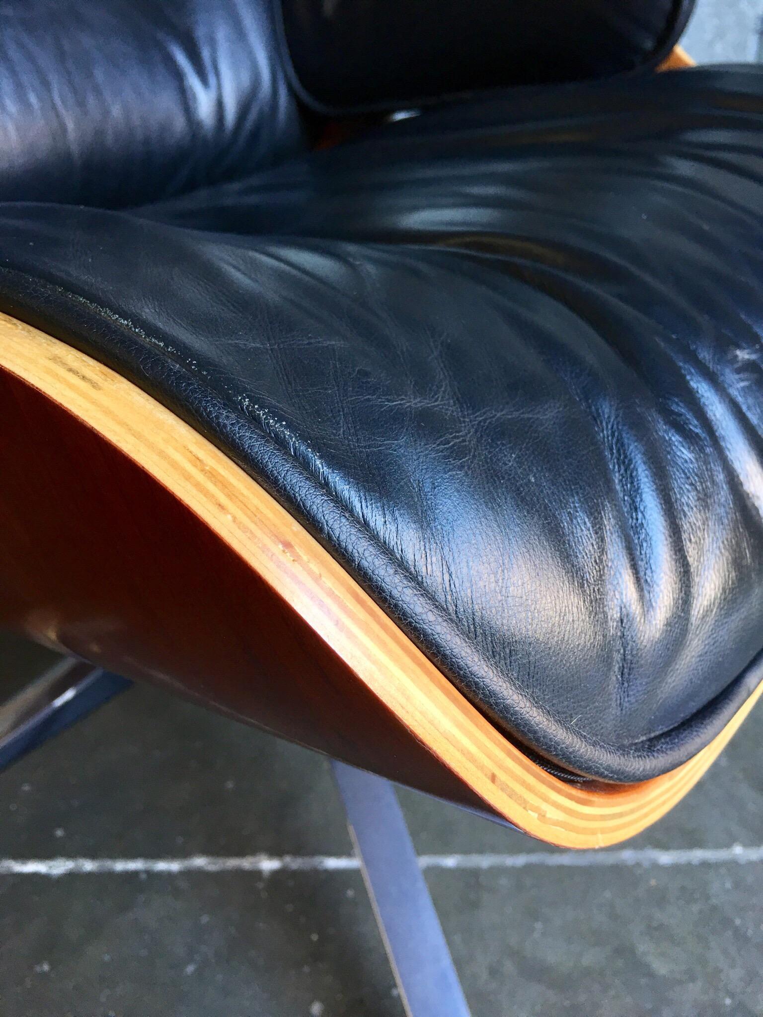 Contemporary black leather and plywood lounger with matching footstool 1