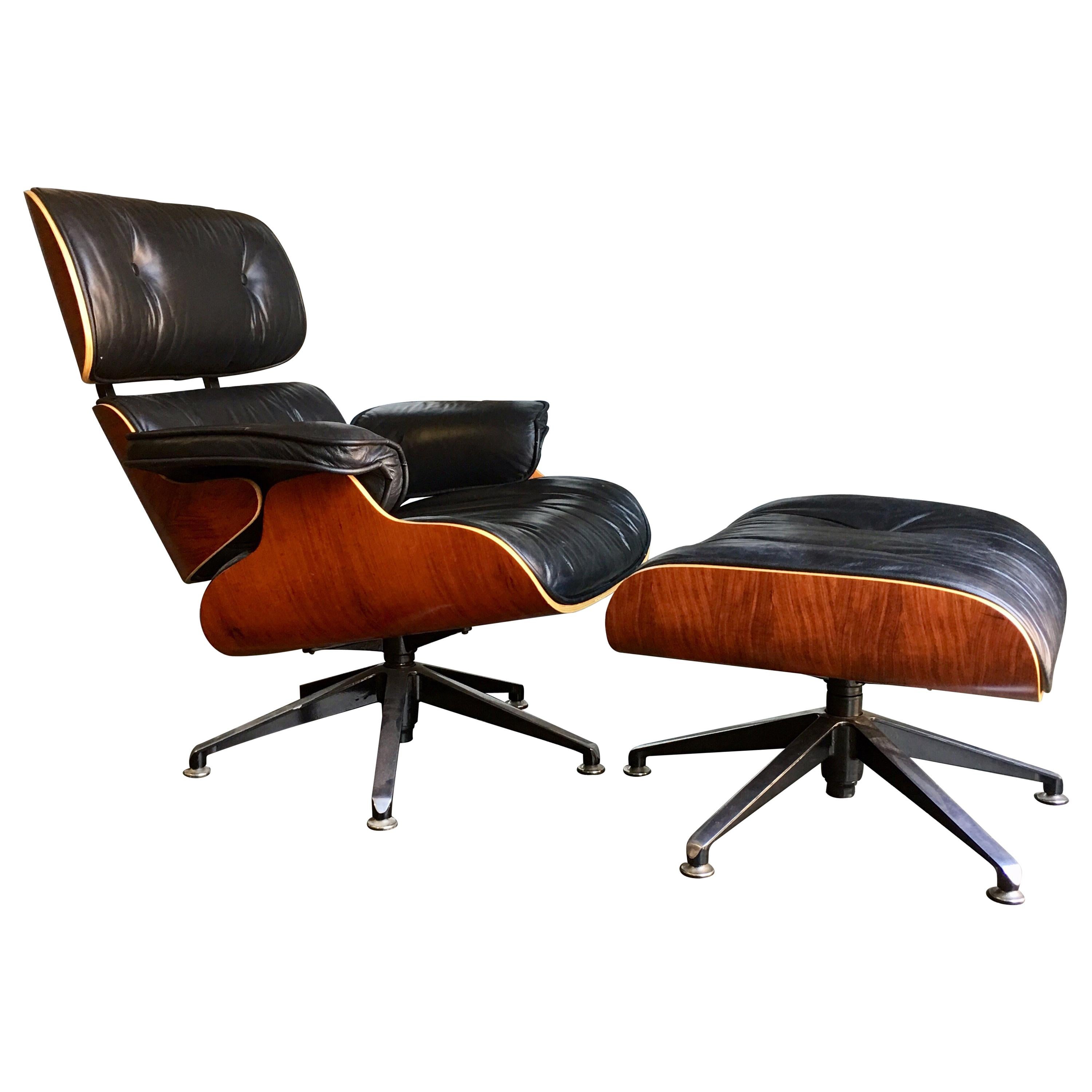 Contemporary black leather and plywood lounger with matching footstool