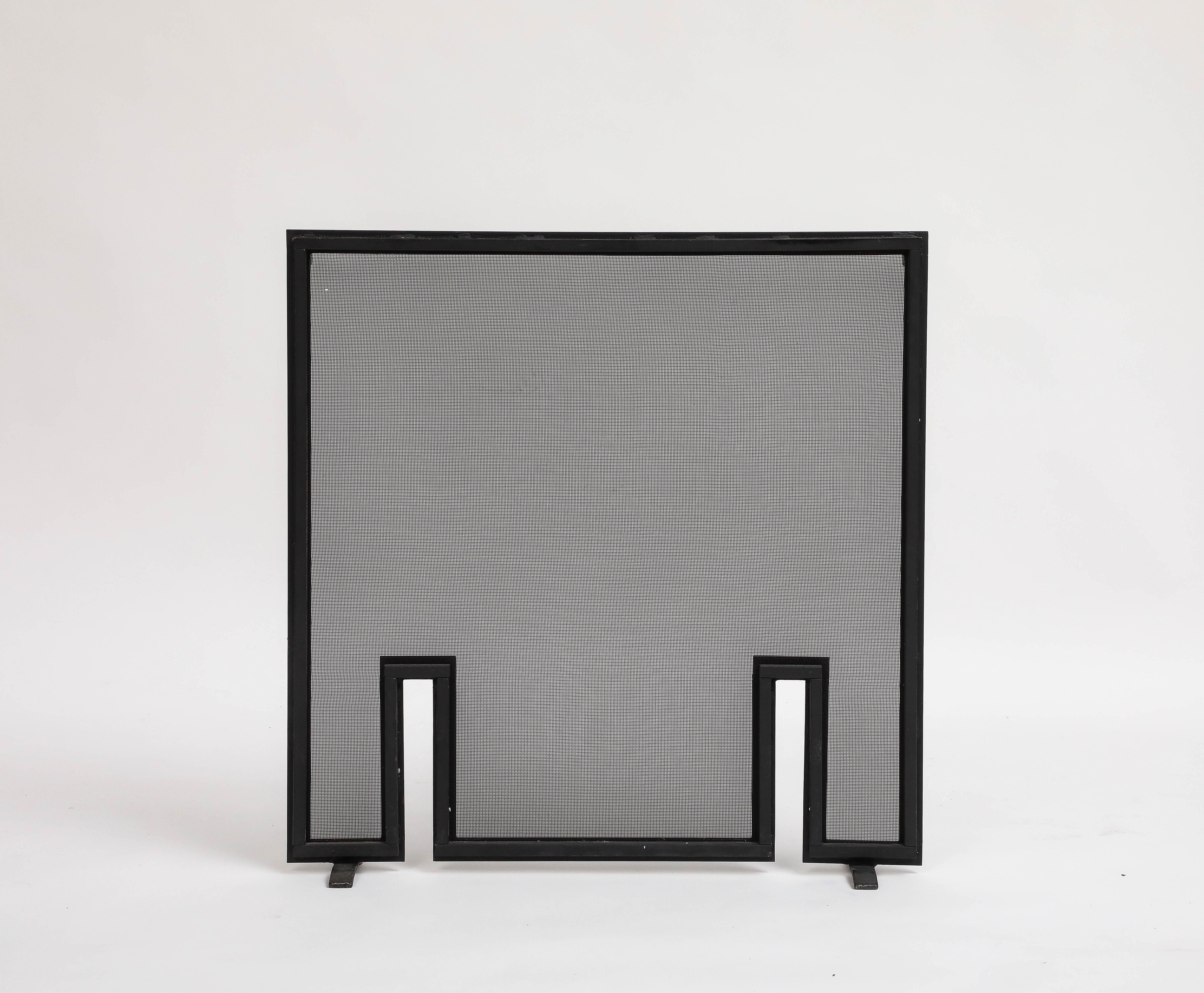 Contemporary black metal mesh firescreen, 21st Century. Minimalist black metal frame and two vent/cutouts near the feet give it interest and shape. 