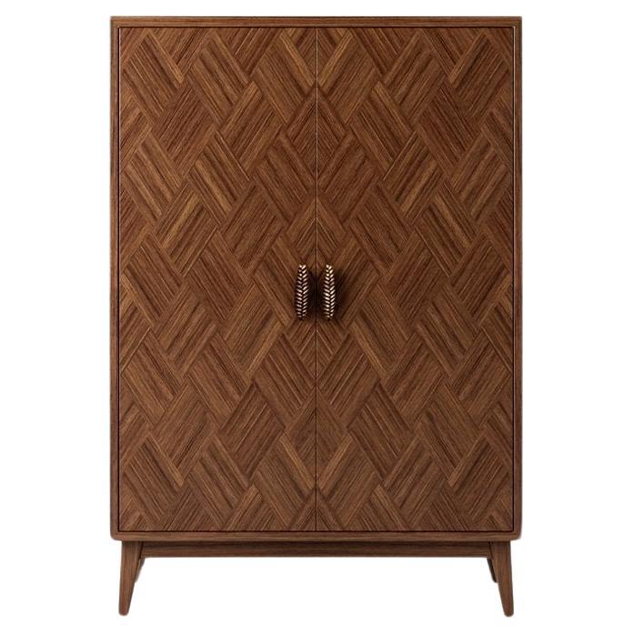 The contemporary cabinet features an intricate marquetry inlay along with bronze handles fashioned after wheat branches. Marquetry, an ancient artistic technique, involves layering veneers to form organic motifs, reflecting traditional
