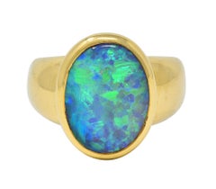Contemporary Black Opal 18 Karat Yellow Gold Puffed Bezel Gemstone Ring
