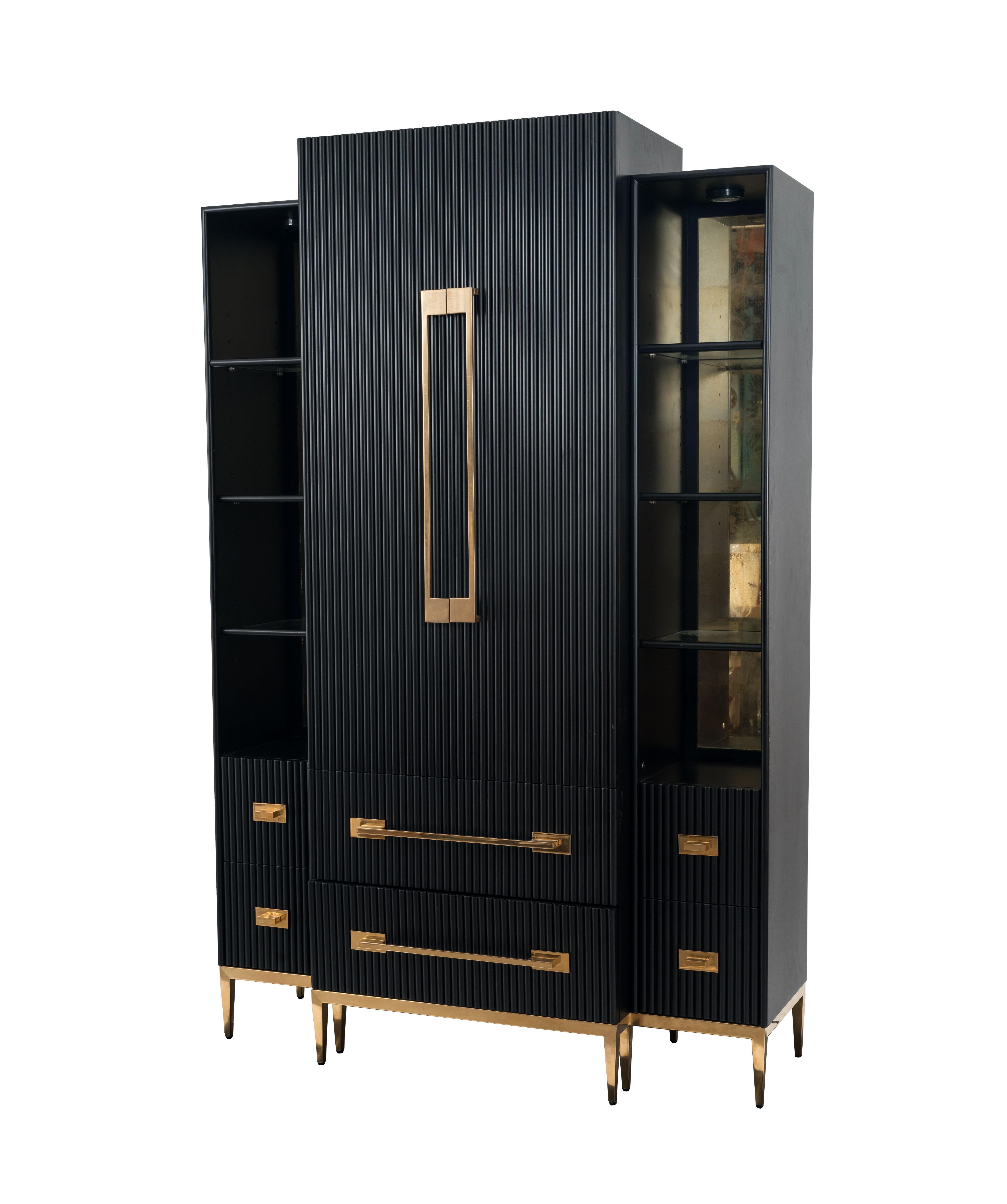Contemporary black satin cabinet with two front doors centered between 2 lighted side shelves. Two bottom drawers, & four smaller side drawers having gilt metal legs and detail. (JOHN-RICHARD)
