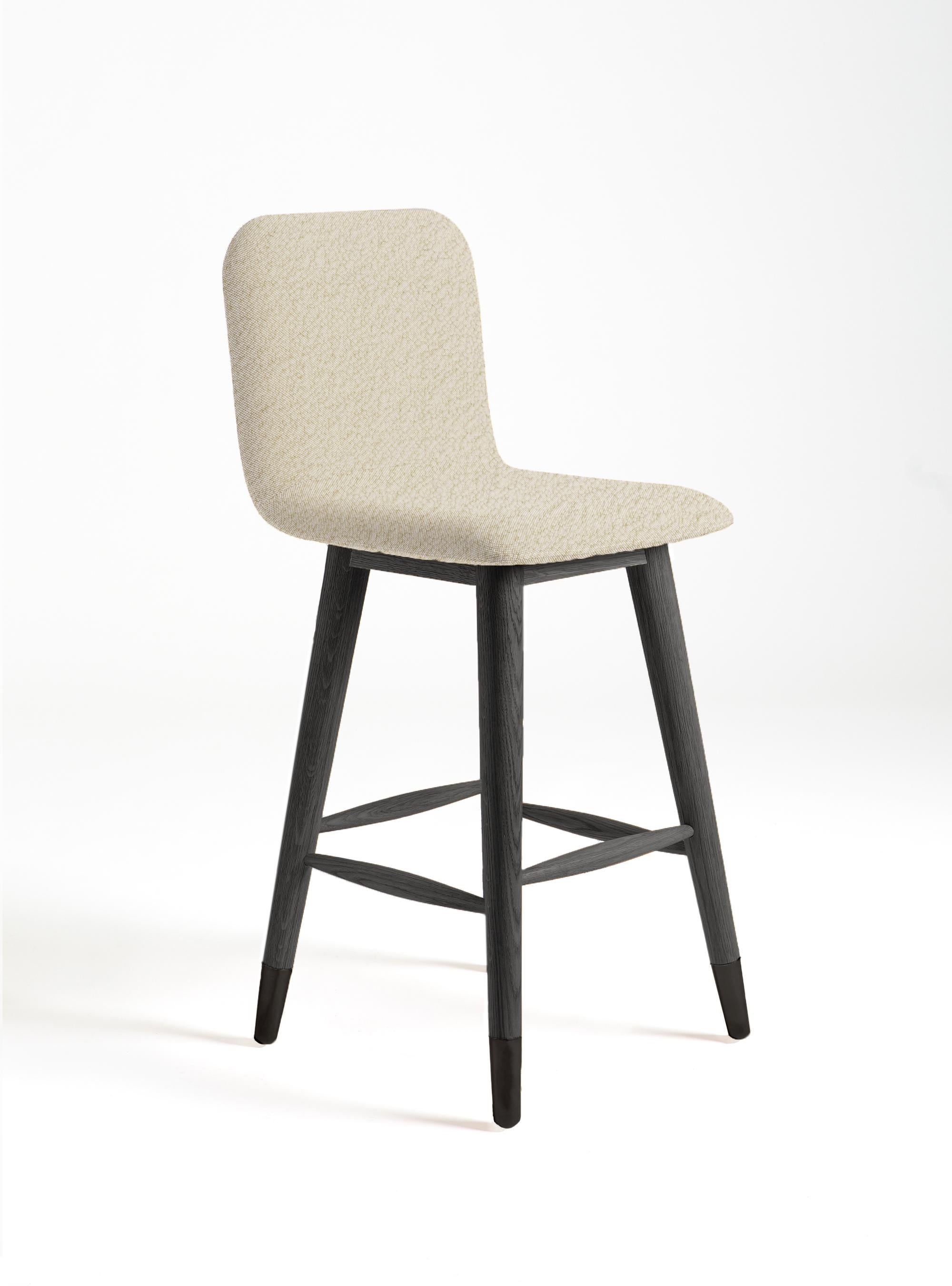 Mistral bar stool is designed to bring fresh, modern, natural style to its environment. Black polished metal and black stained oak legs are combined with elegant white boucle fabric.