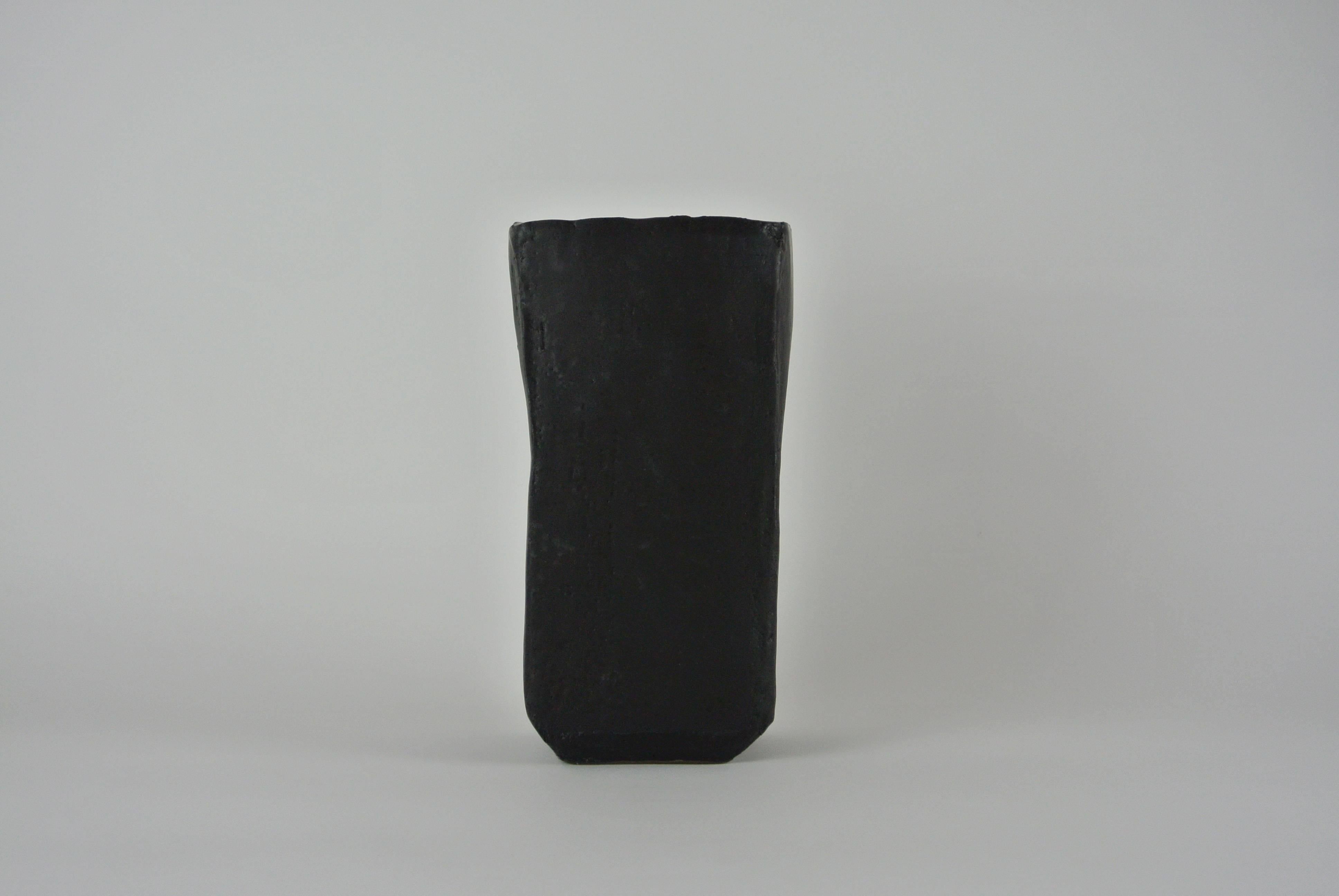 Large stoneware vase in smooth black stoneware with a black matte glaze. Slightly asymmetric shape. Functional and holds water.