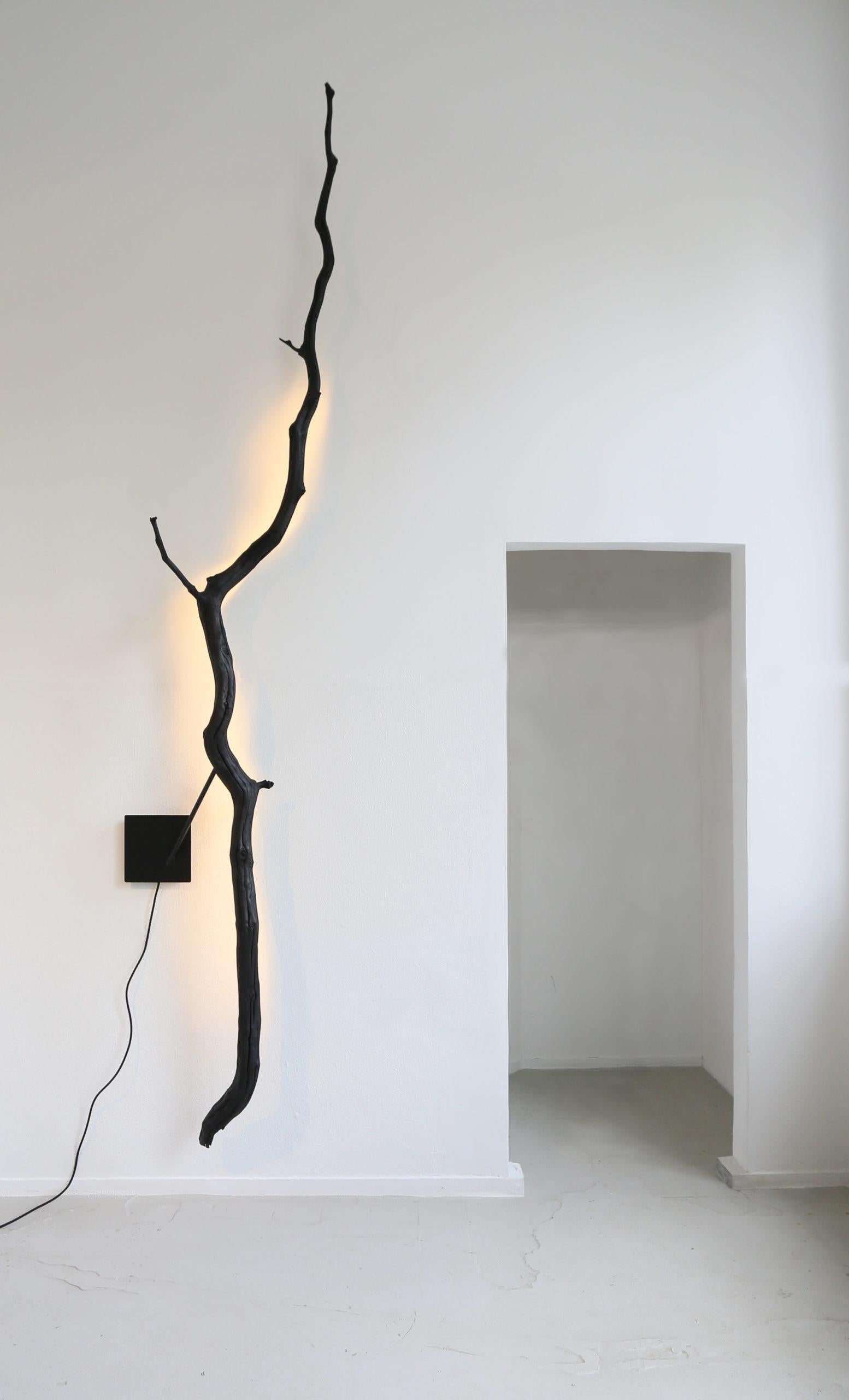 Contemporary black wooden wall light - Burning Ego Wall Lamp by Wim Verzantvoort for WDSTCK

Design: Wim Verzantvoort
Materials: Burned Oak wood
Features: Dimmable LED driver

Prices: 
< 220 cm: € 5.160,-
< 300 cm: € 6.020,-
> 300 cm: on