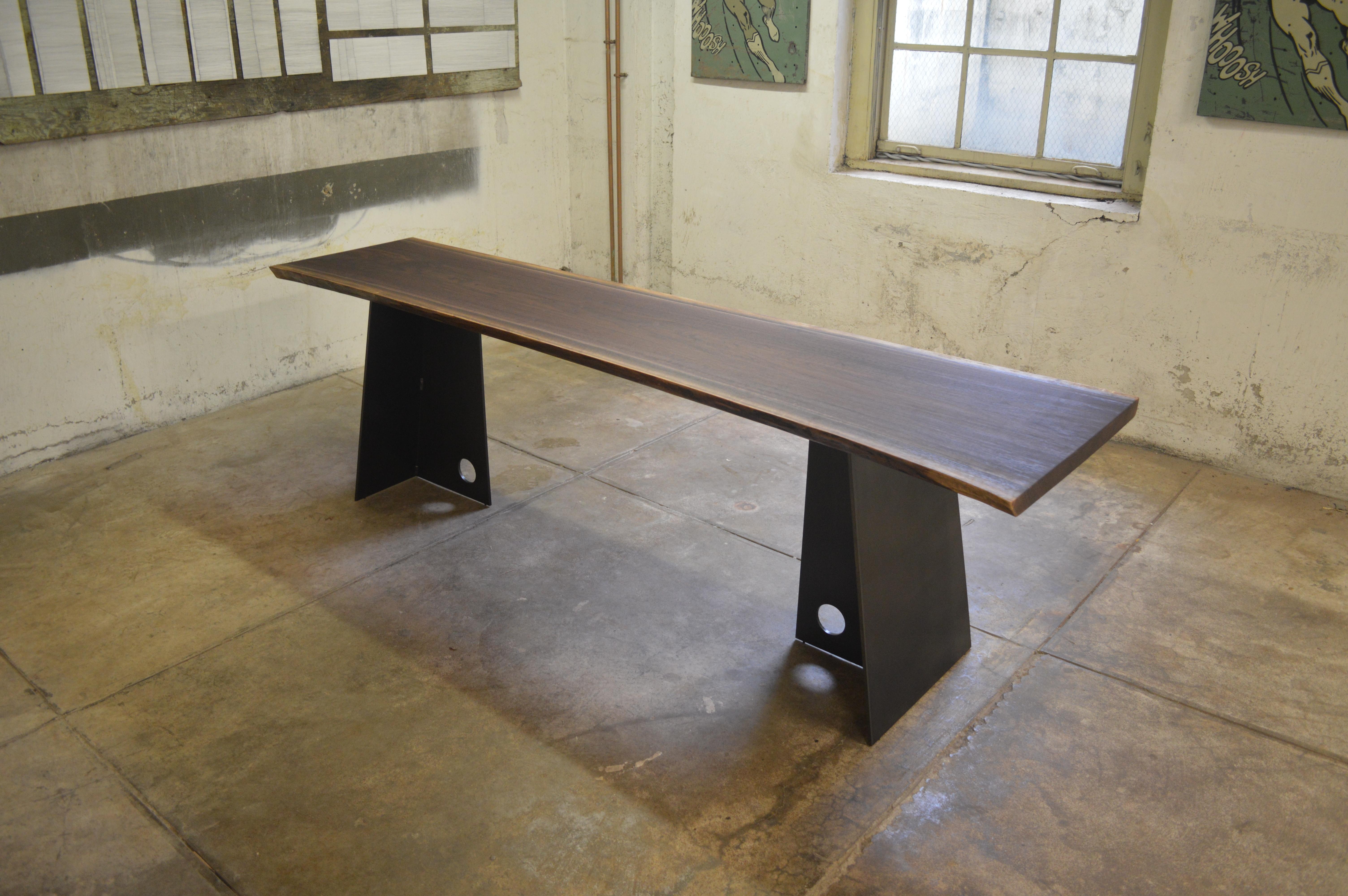 The Hendricks Bridge console, an original design offered exclusively by Vermontica, is a contemporary minimalist blackened steel and walnut top console designed and produced in Vermont by Scott Gordon. It features a 3/8